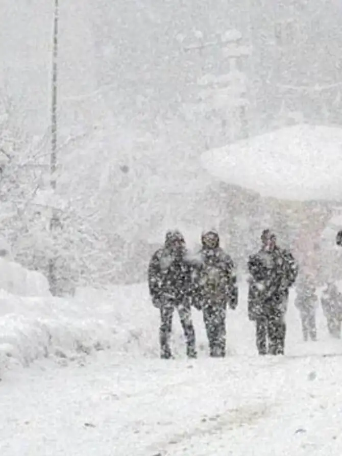 A group of people walking on a snowy street. A group of people walking on a snowy street.