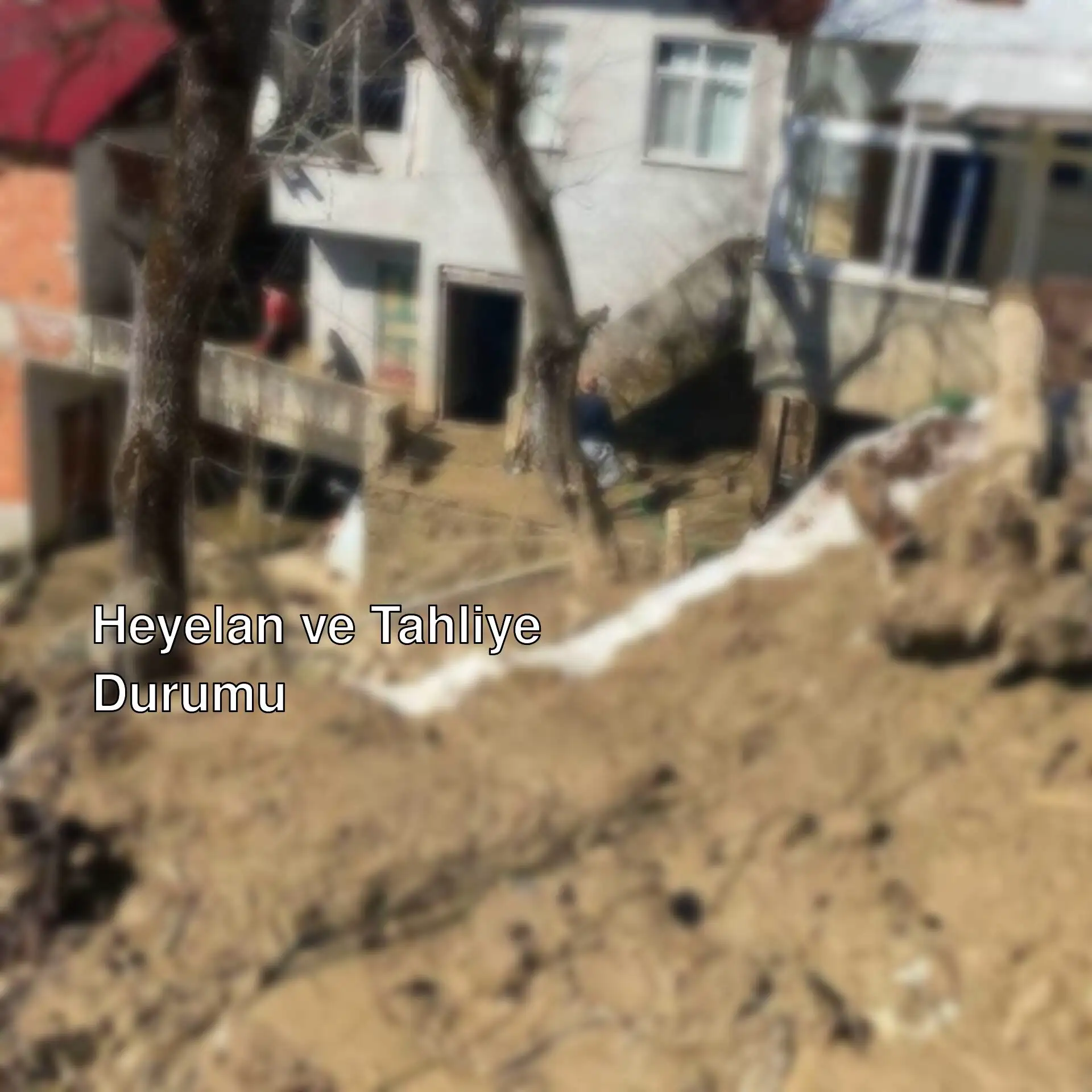 A muddy hill with trees and houses in the background