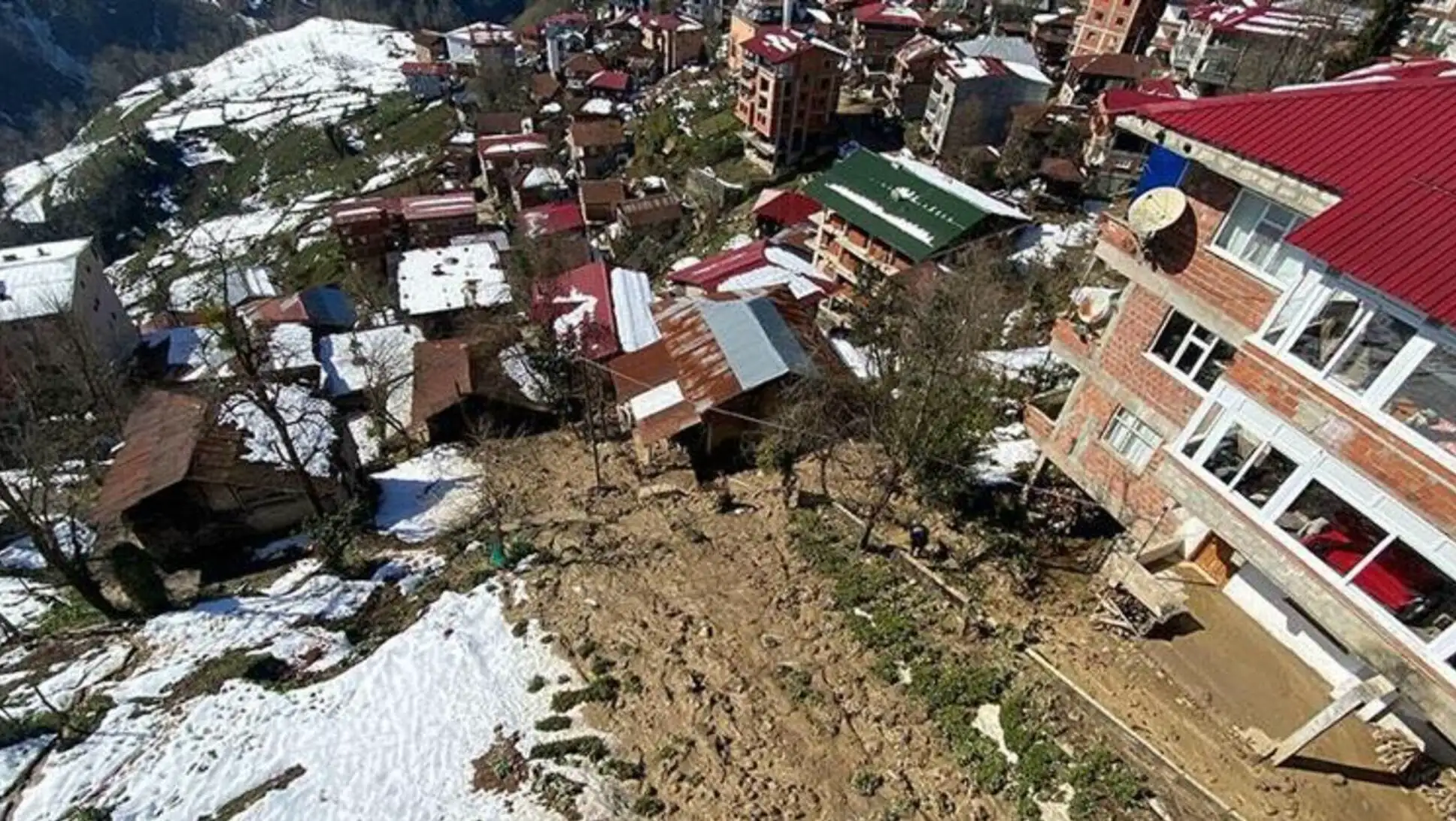 A group of buildings on a hill with snow