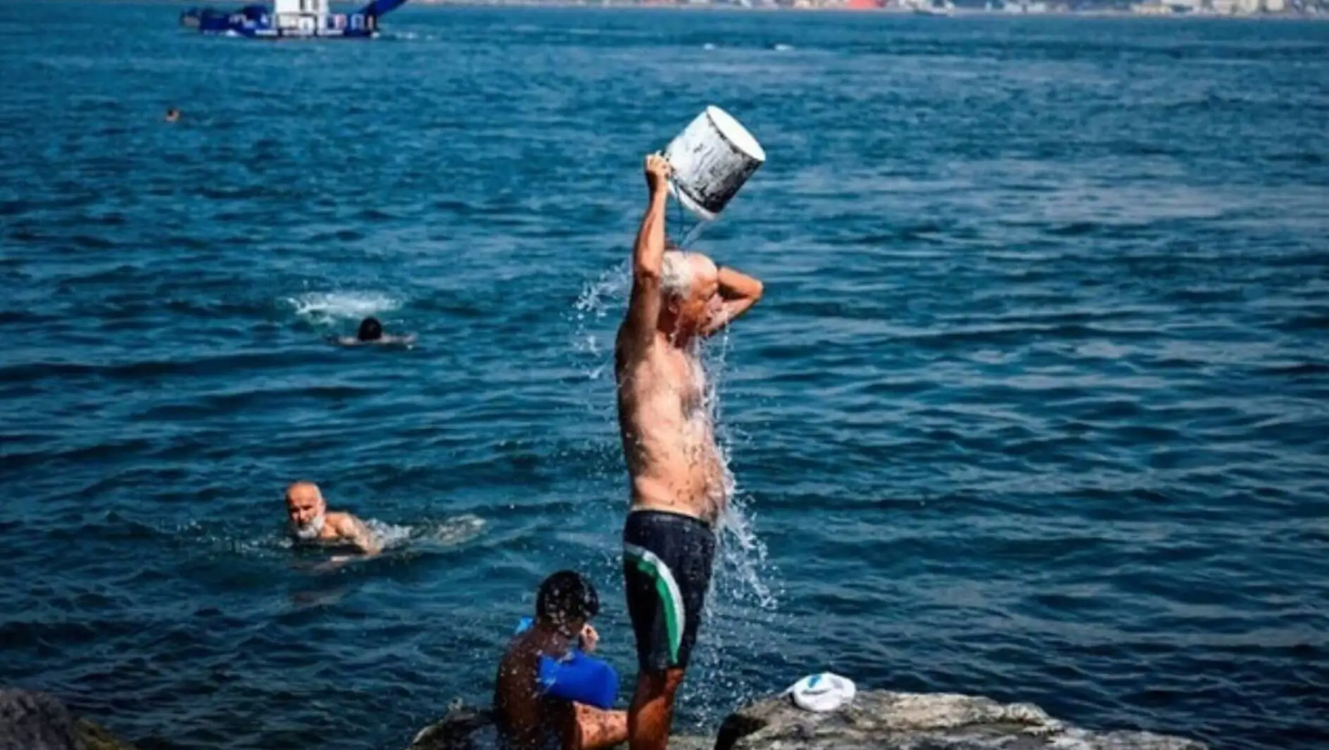 A man standing in water due to heat waves. A man standing in water due to heat waves.