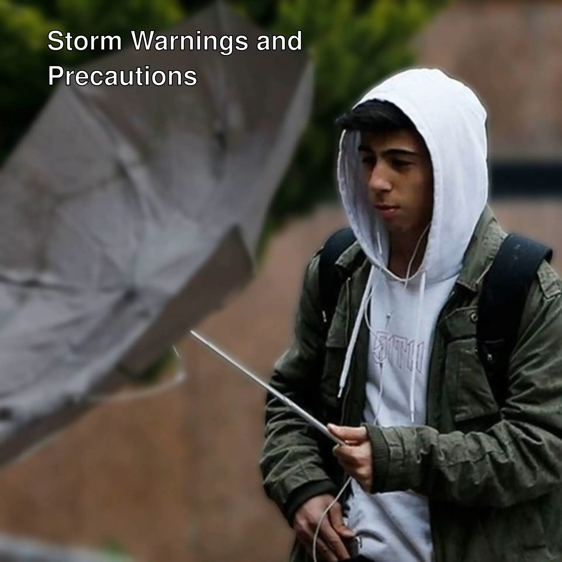 A man wearing a white hoodie and holding an umbrella. A man wearing a white hoodie and holding an umbrella.