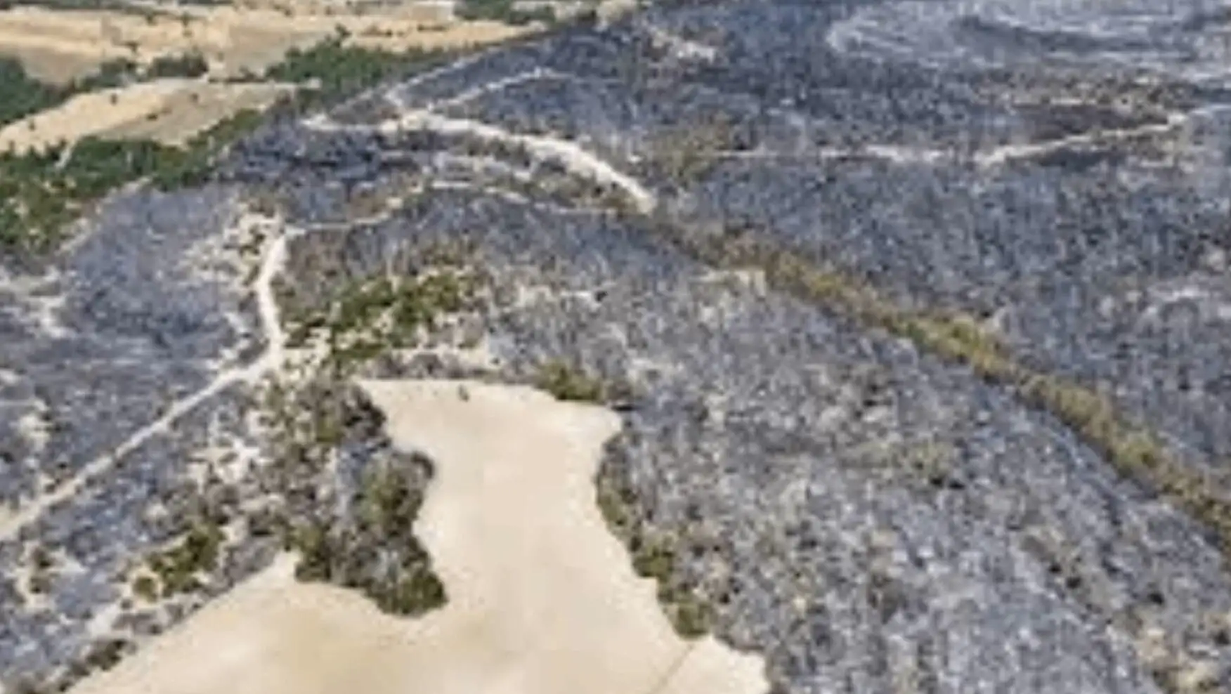 Aerial view of a rocky area affected by fire.