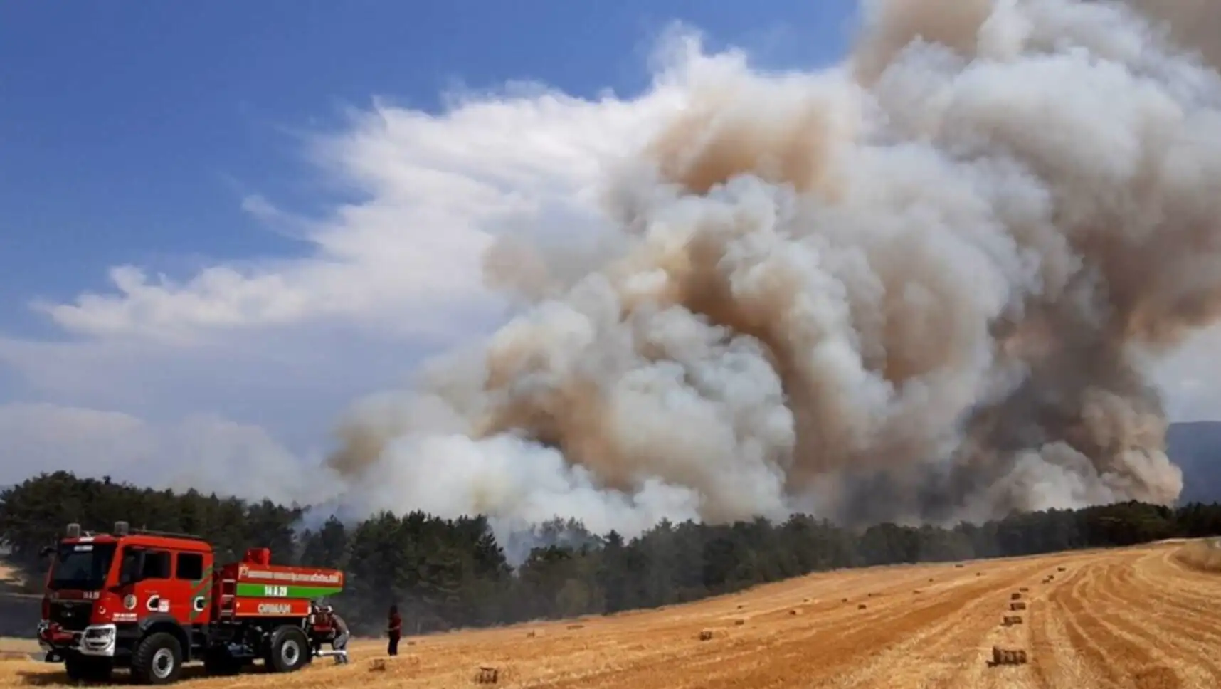 A helicopter dropping water on a forest fire. A helicopter dropping water on a forest fire.