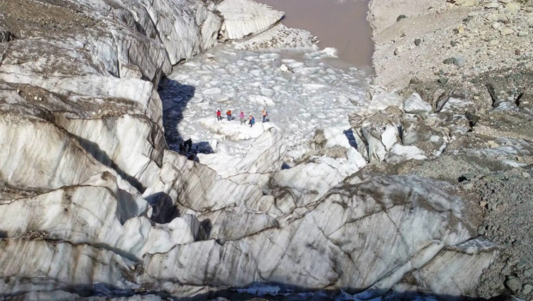 A group of people standing in a river. A group of people standing in a river.