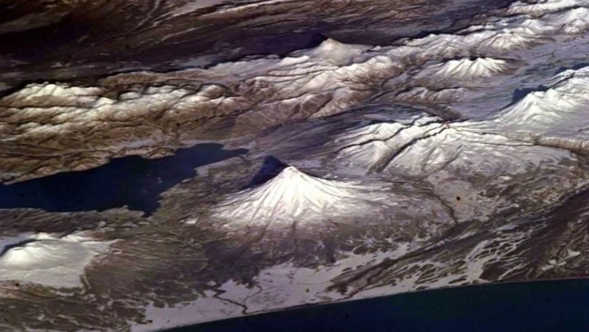 Aerial view of a snowy mountain. Aerial view of a snowy mountain.