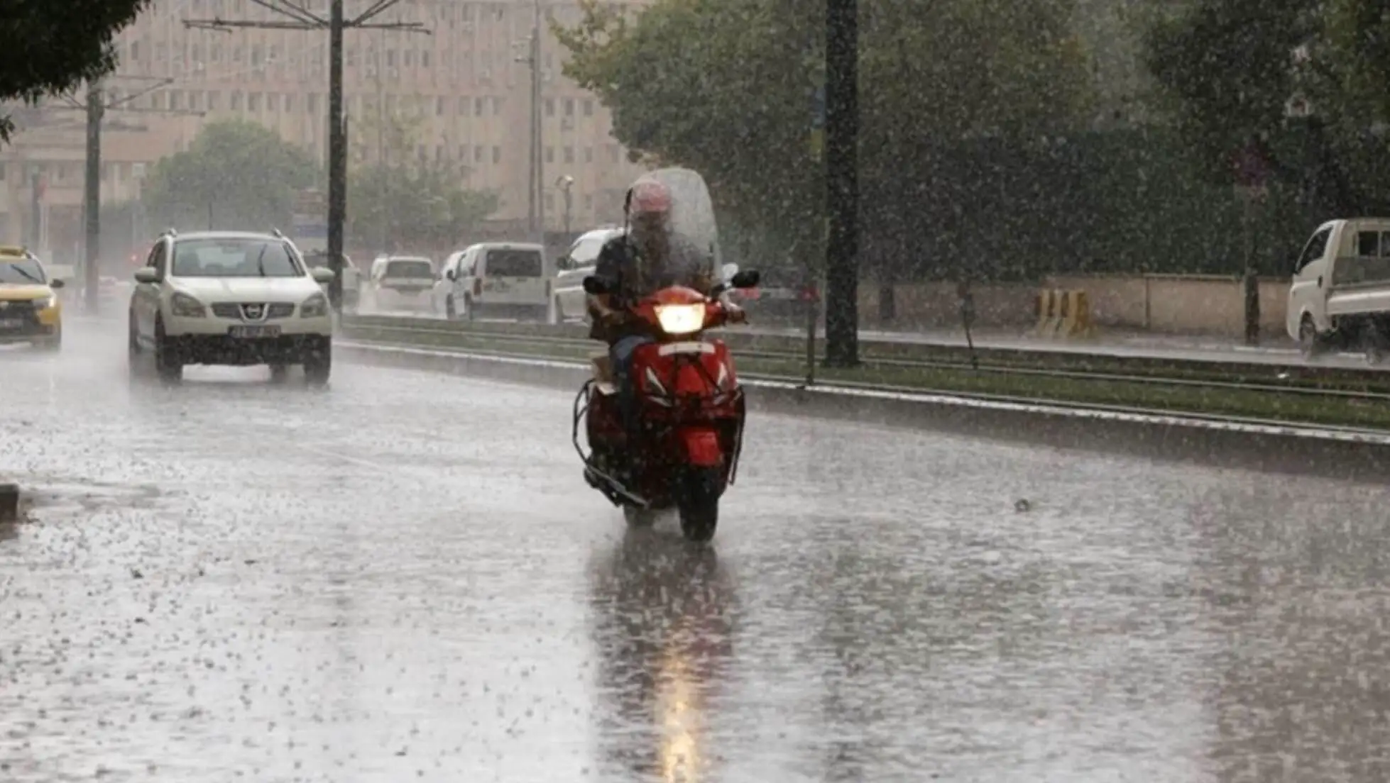 A person riding a motorcycle in the rain. A person riding a motorcycle in the rain.