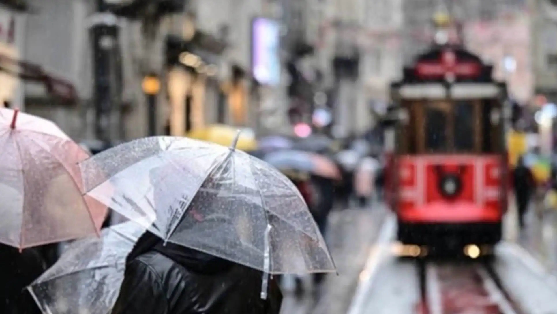 A person holding an umbrella in the rain.