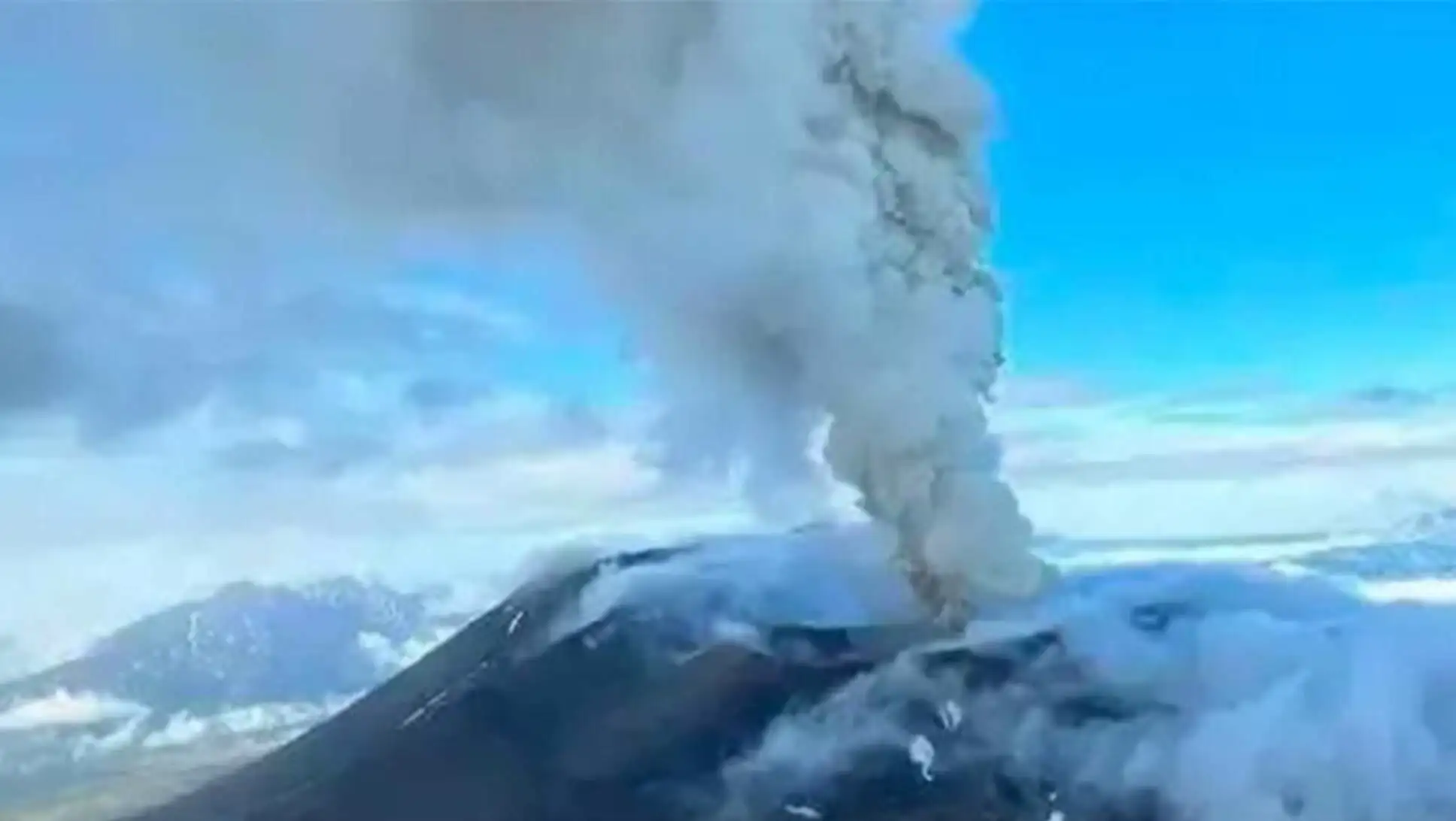 A volcano erupting with smoke.