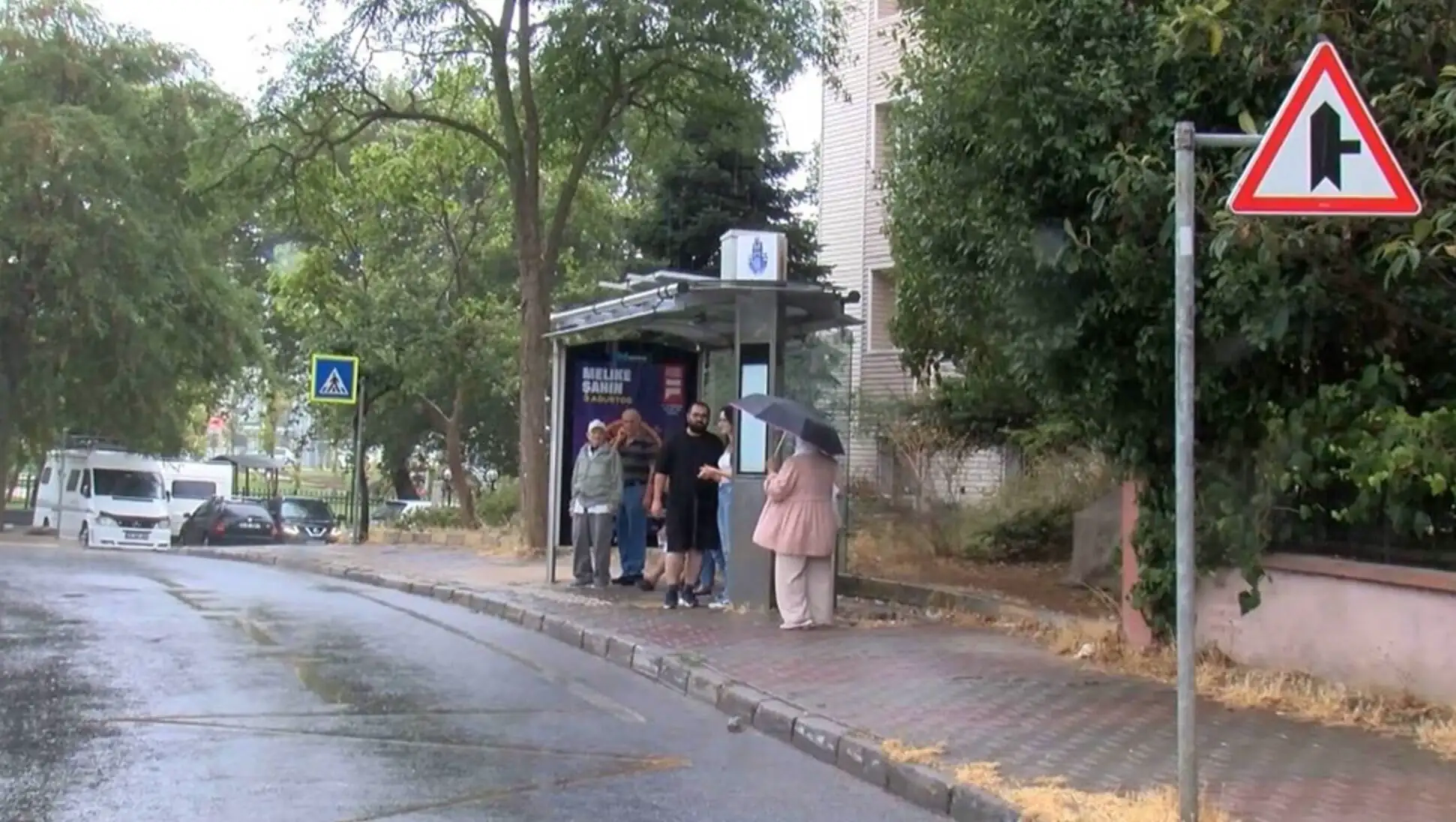 A group of people walking in the rain.