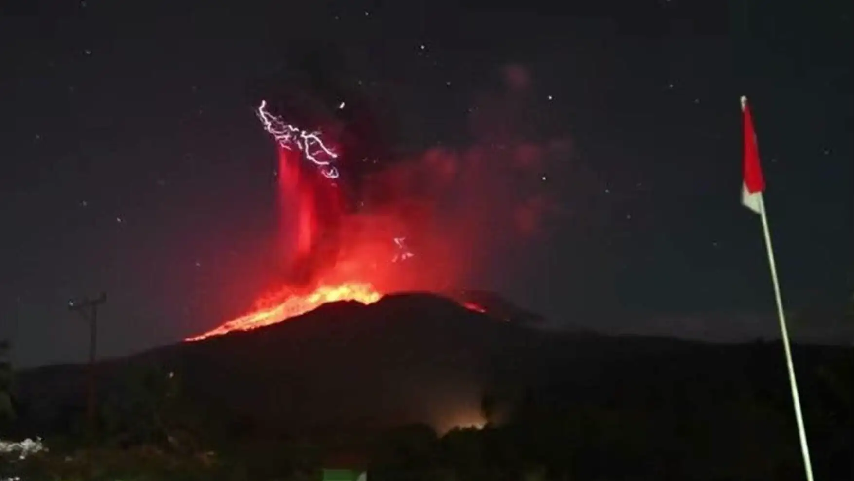 A volcano erupting at night. A volcano erupting at night.