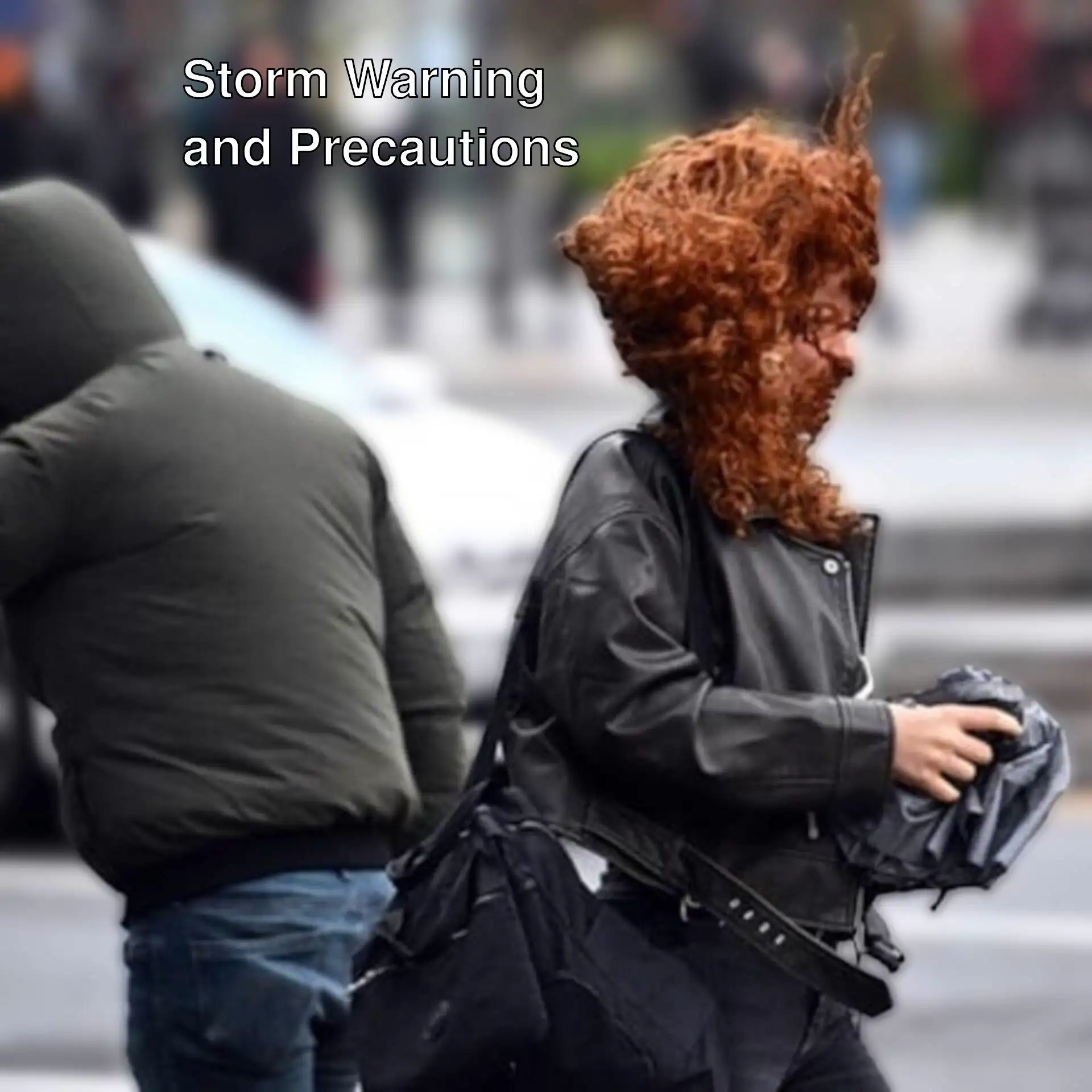 A man walking in preparation for strong winds. A man walking in preparation for strong winds.
