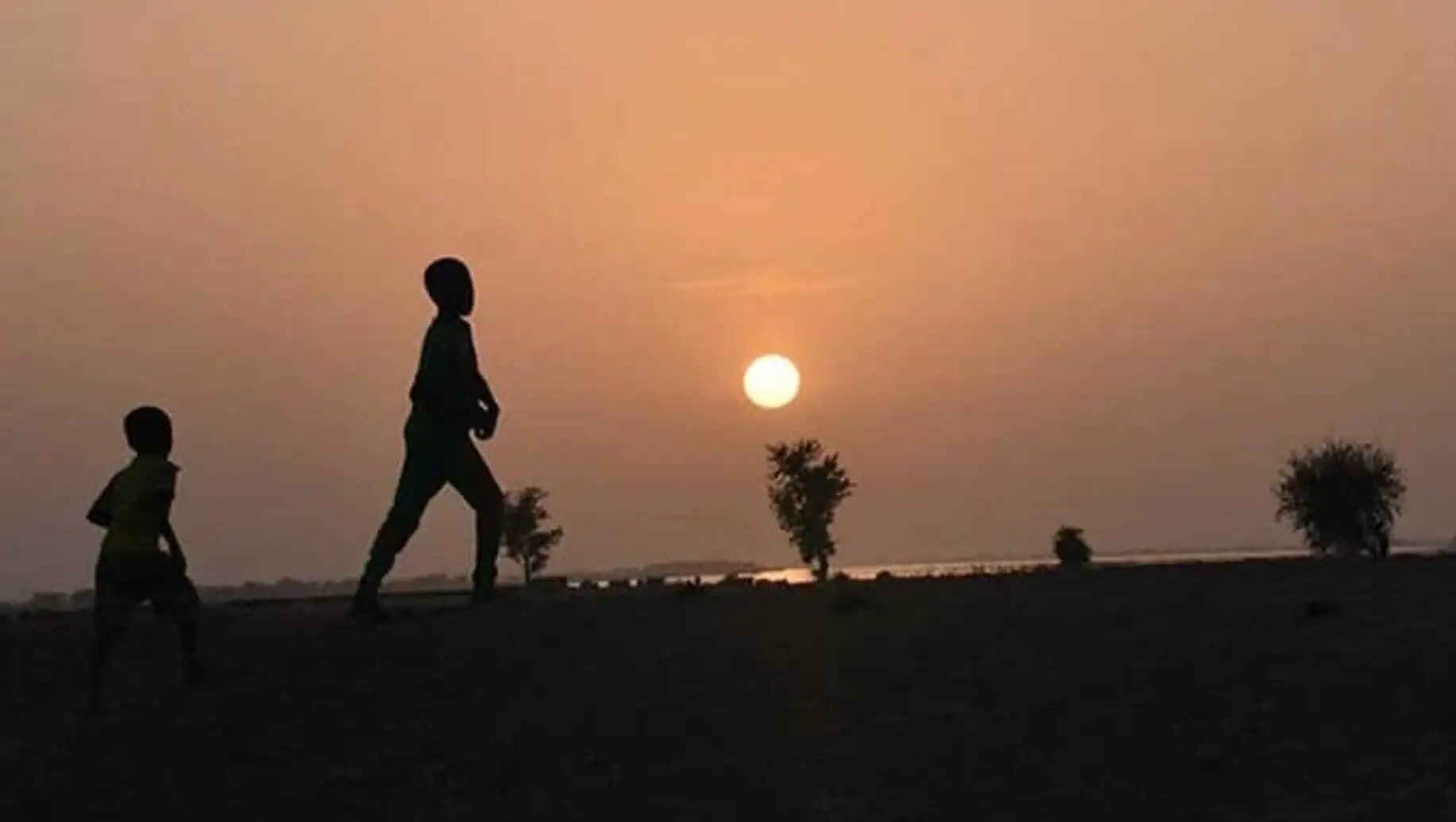 A person walking on a beach. A person walking on a beach.