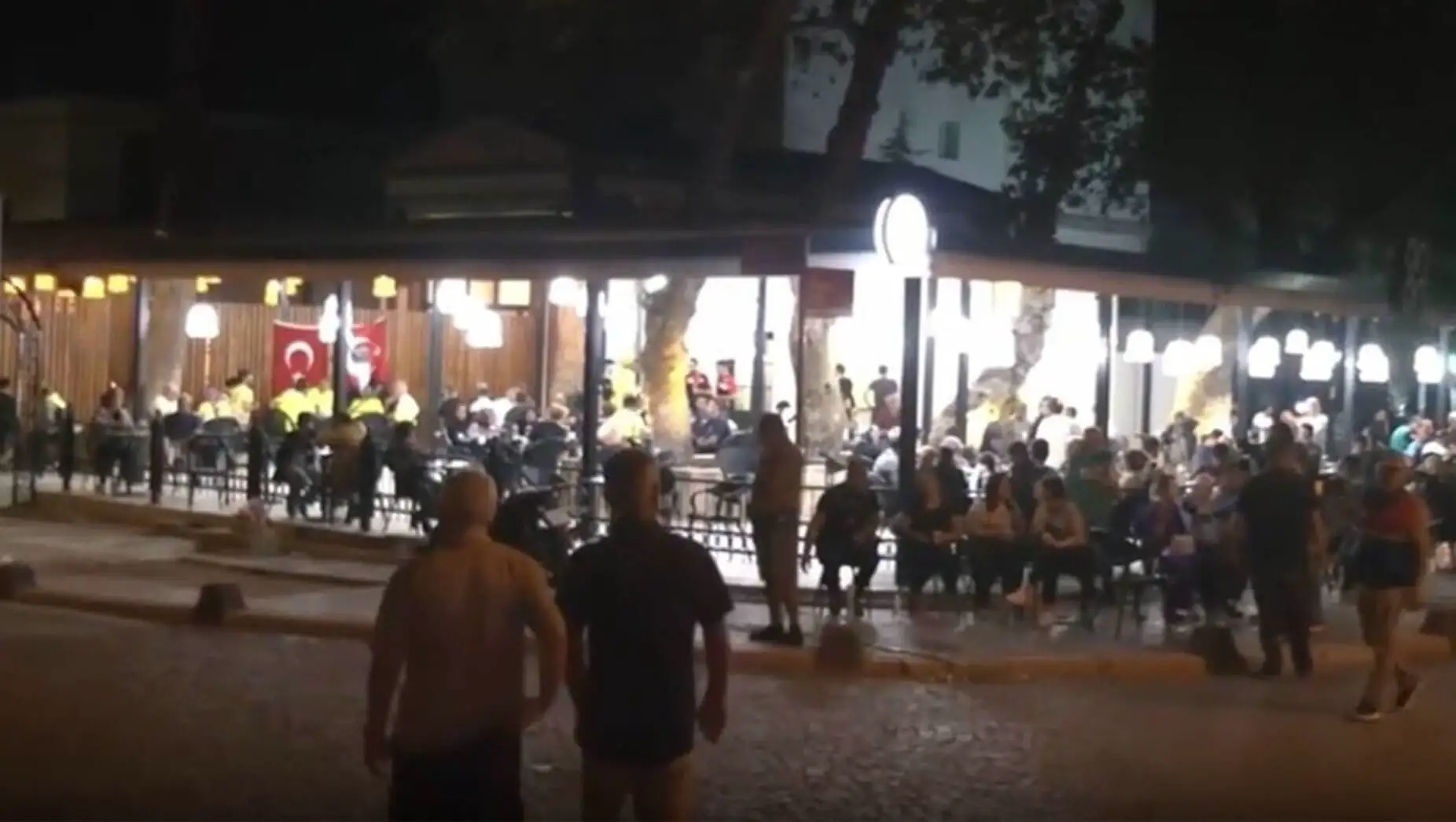A group of people sitting outside in Sındırgı.