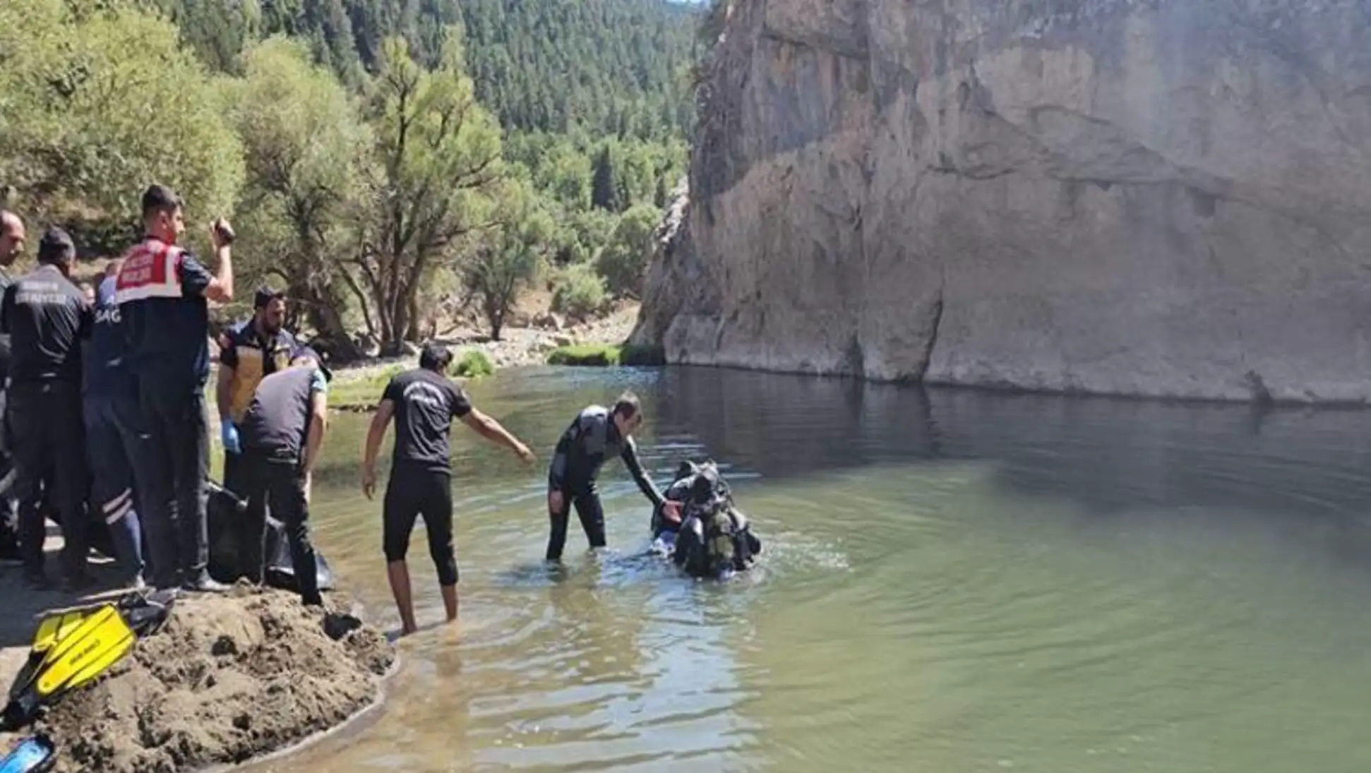 A group of people in a river discussing drought and erosion issues.
