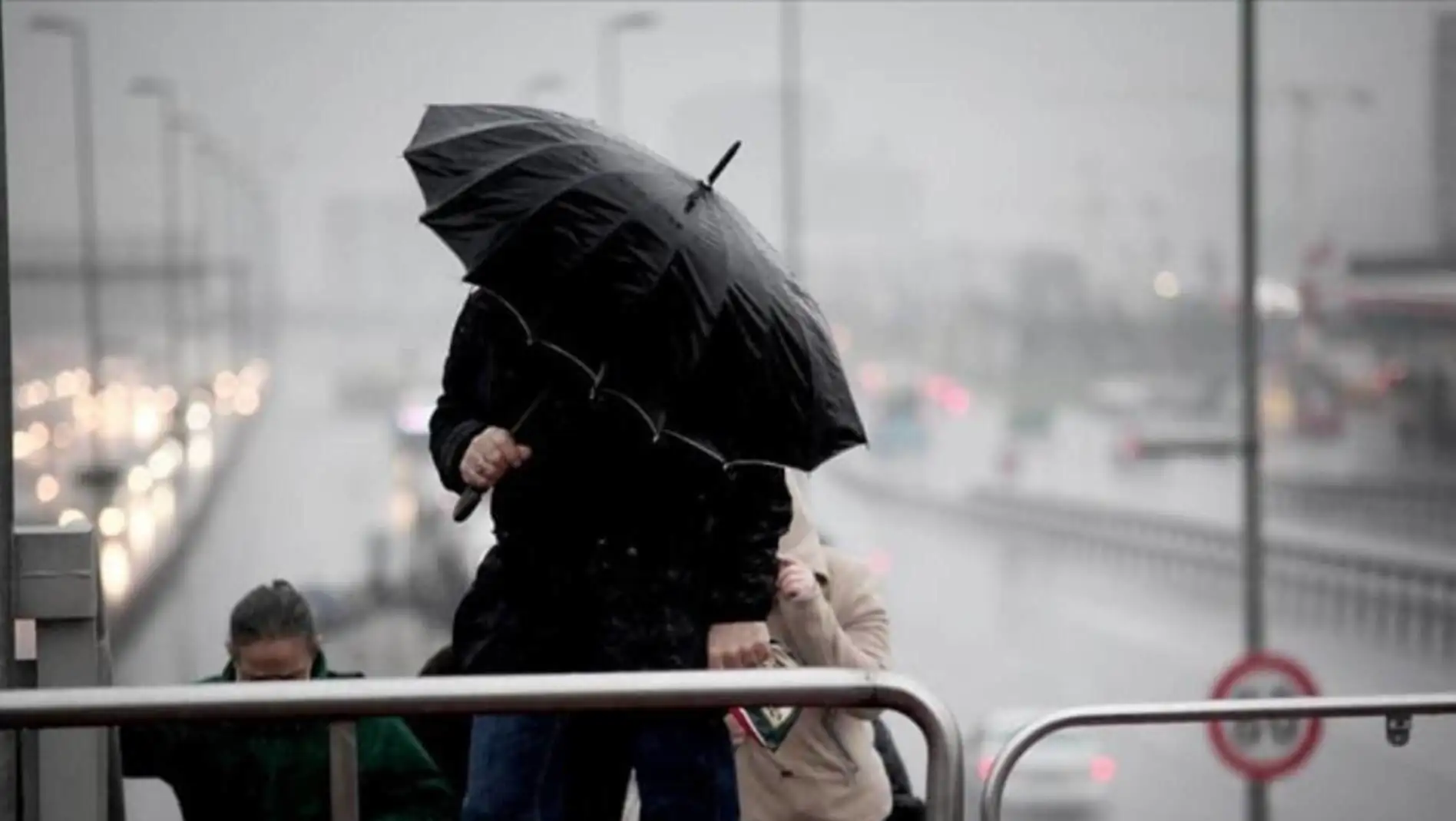 An image of a person holding an umbrella during the storm.