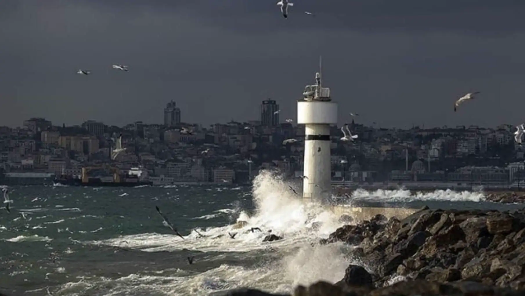 A lighthouse crashing into the water during the storm.