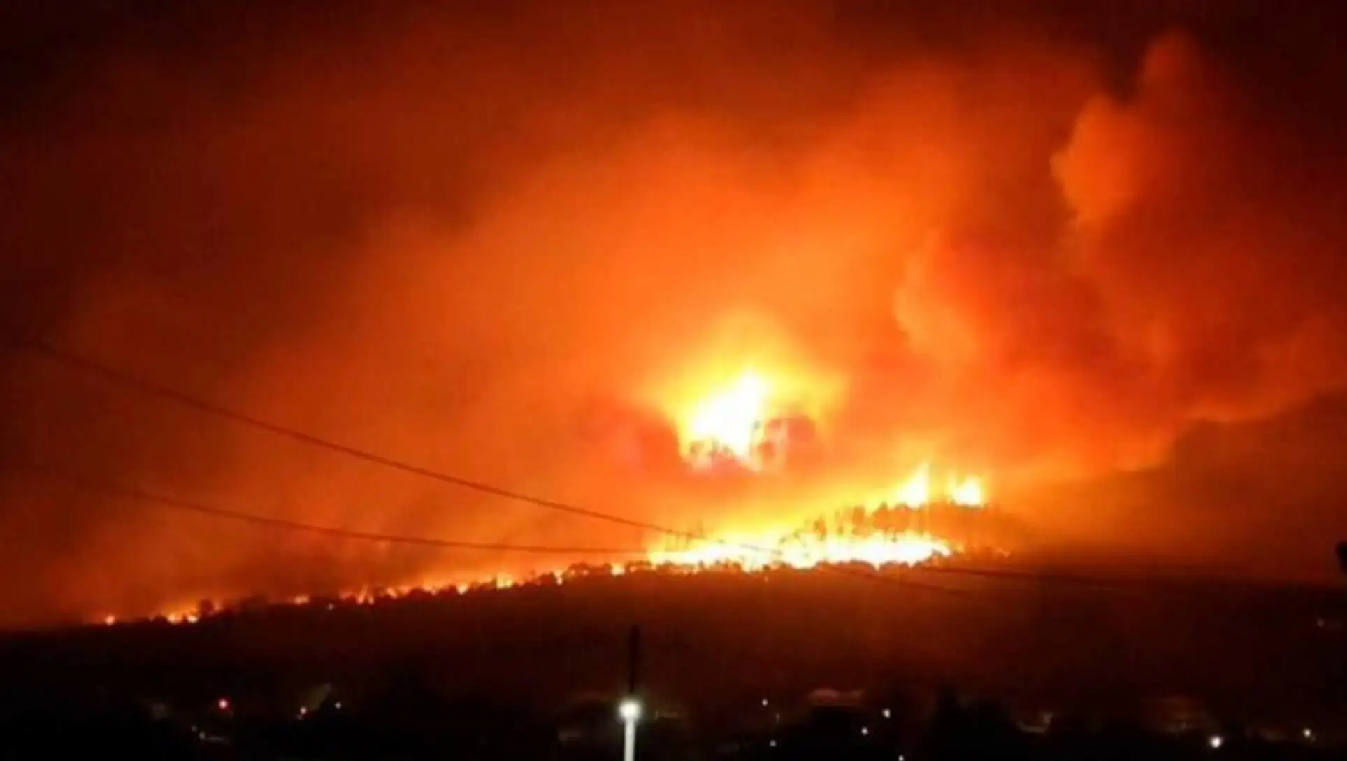 A fire on a hill at night A fire on a hill at night