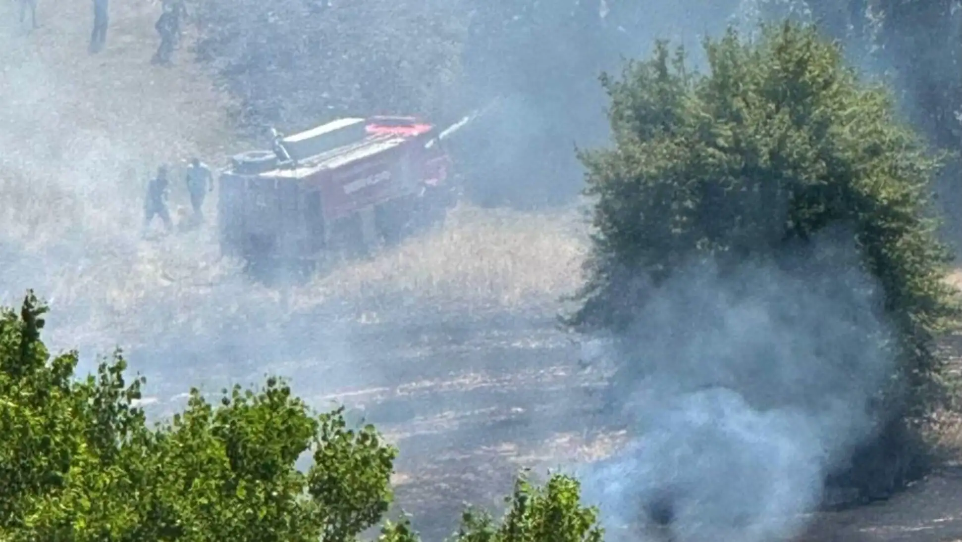A fire truck in a field. A fire truck in a field.