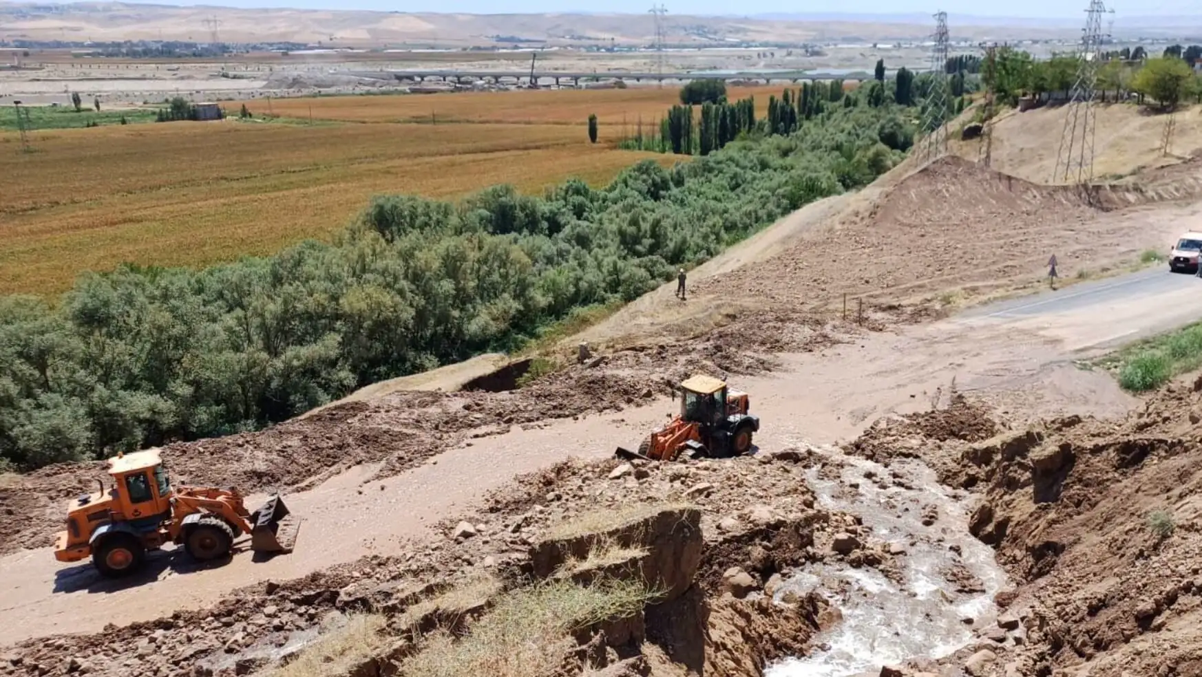 A tractor working on a dirt road. A tractor working on a dirt road.