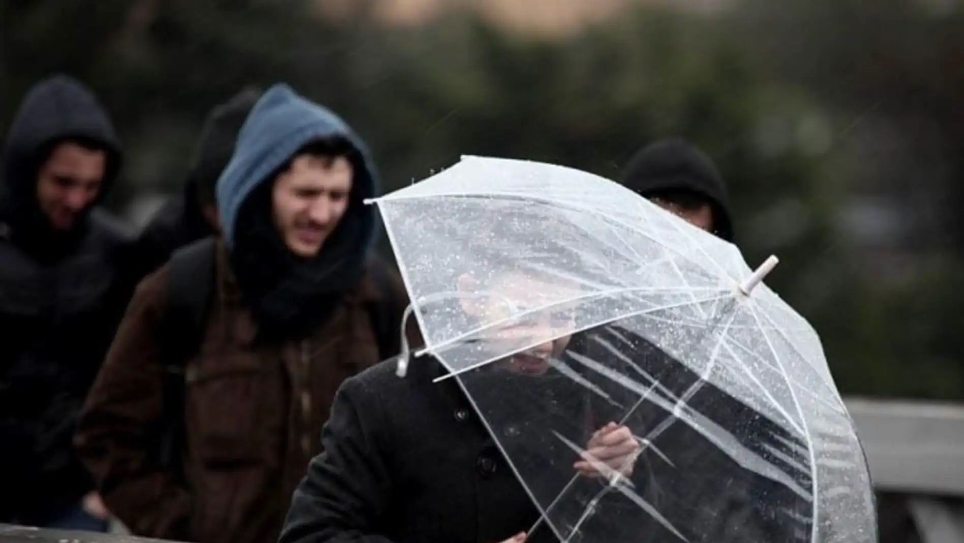 A man holding an umbrella. A man holding an umbrella.