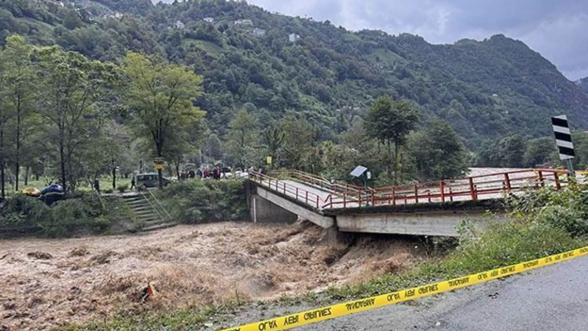 A bridge and muddy river after the flood in Rize.