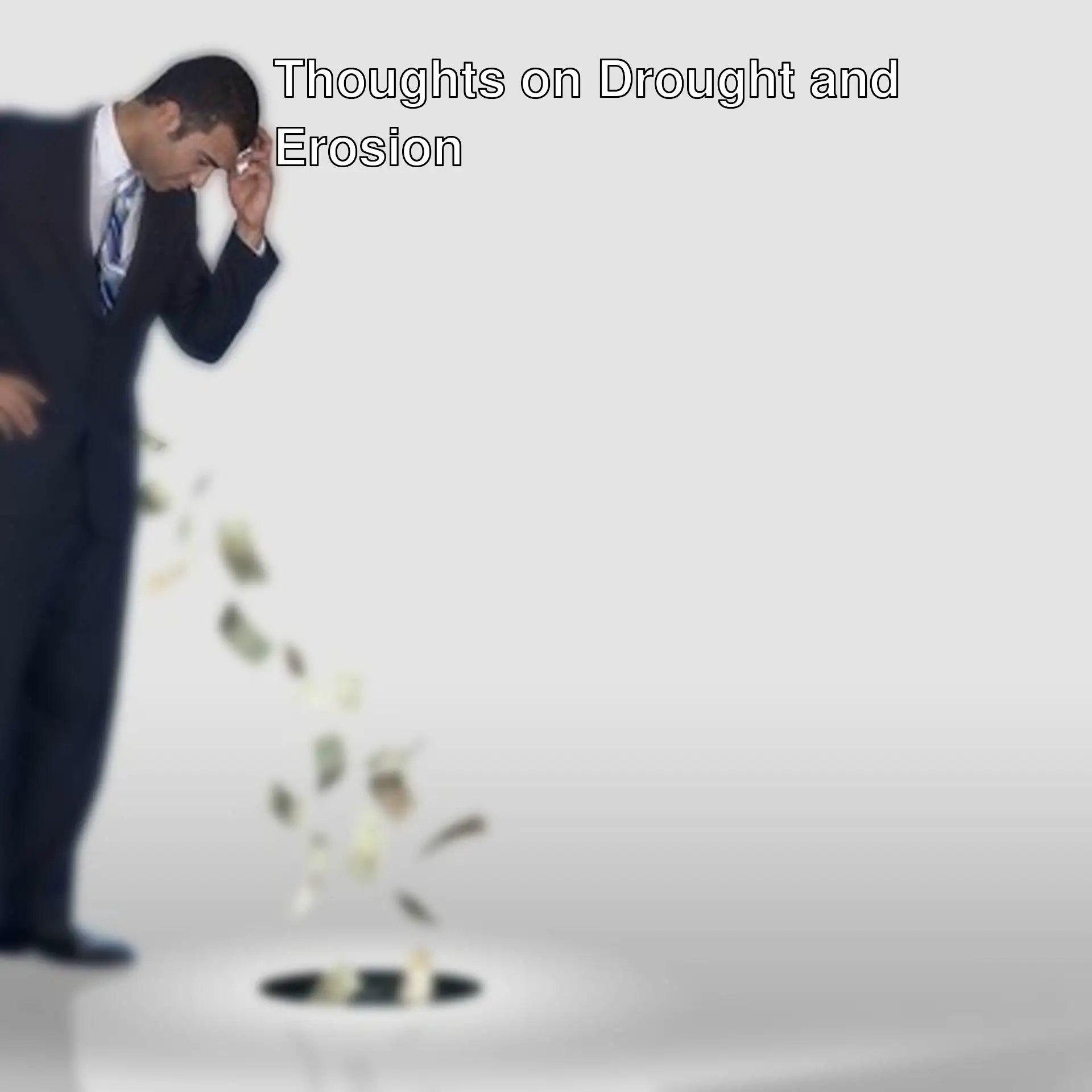 A man looking at money falling from a hole.