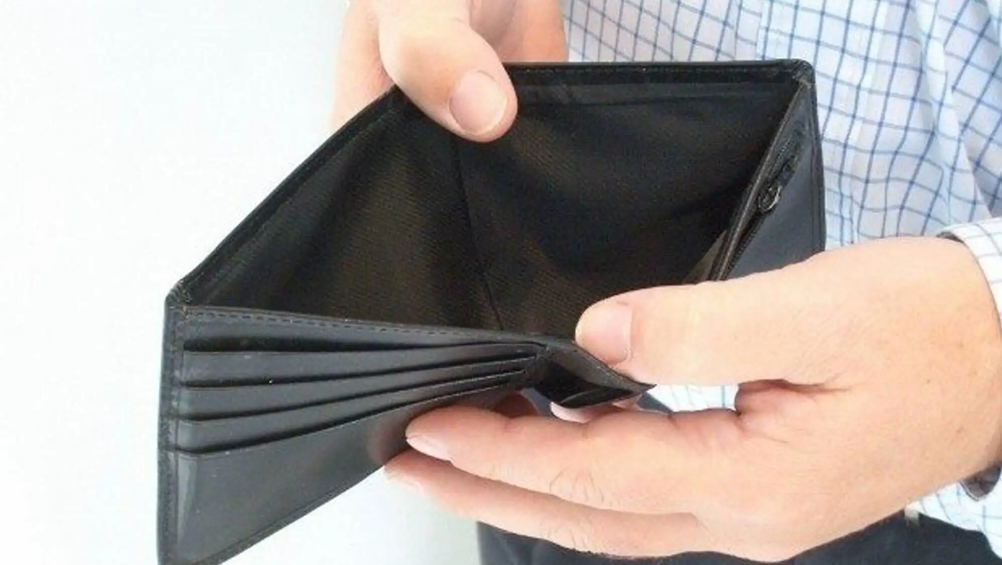 A person holding an empty wallet.