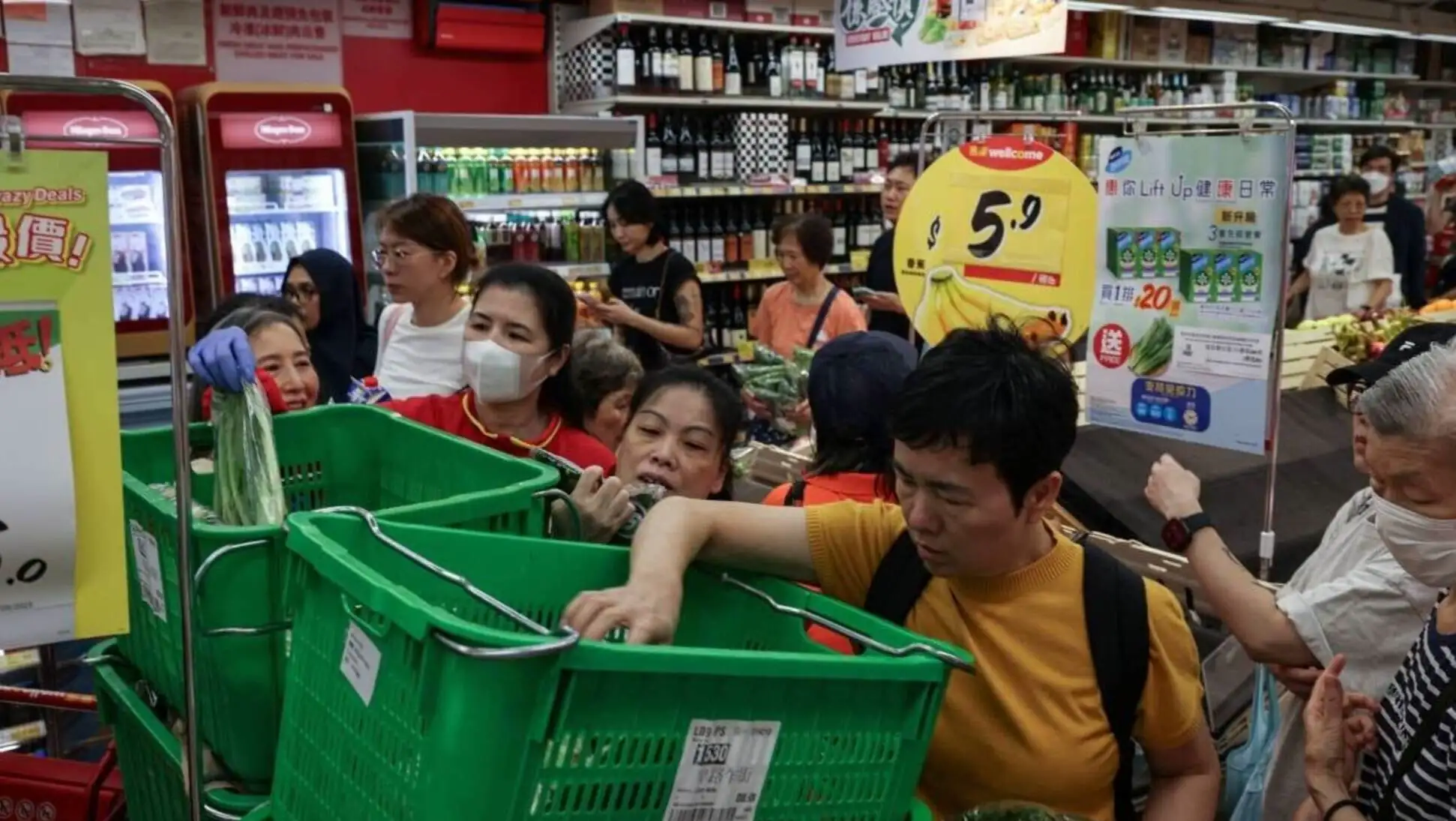 A group of people in a grocery store.