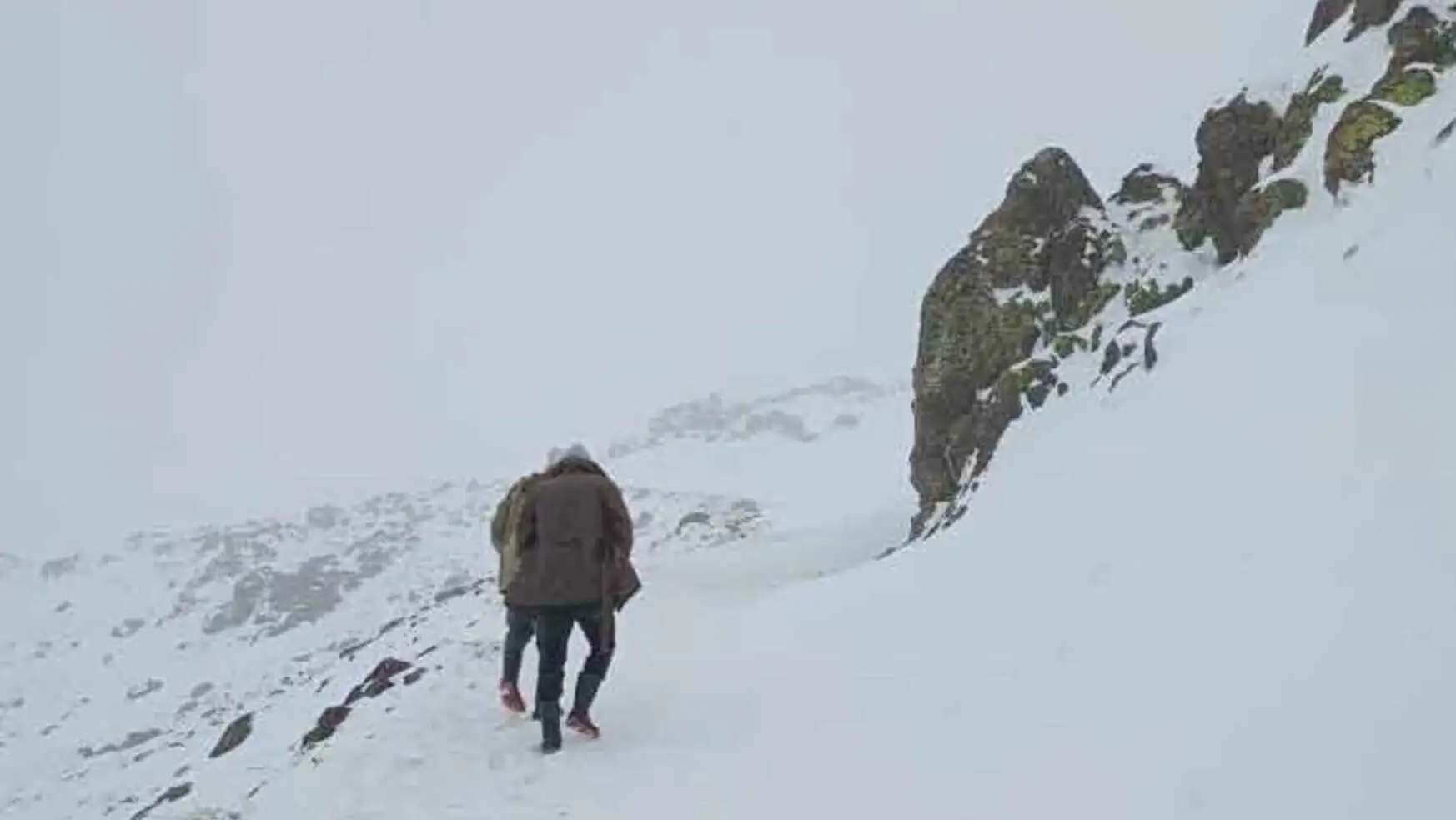 A person walking on a snowy mountain.