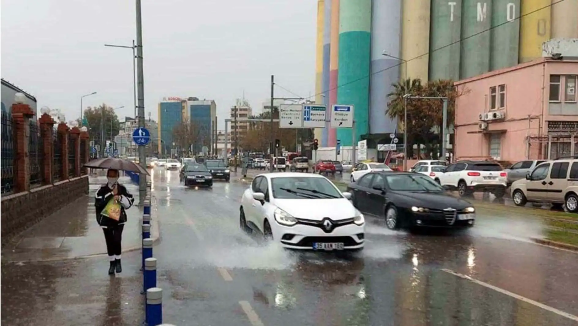 Cars driving on a wet street.