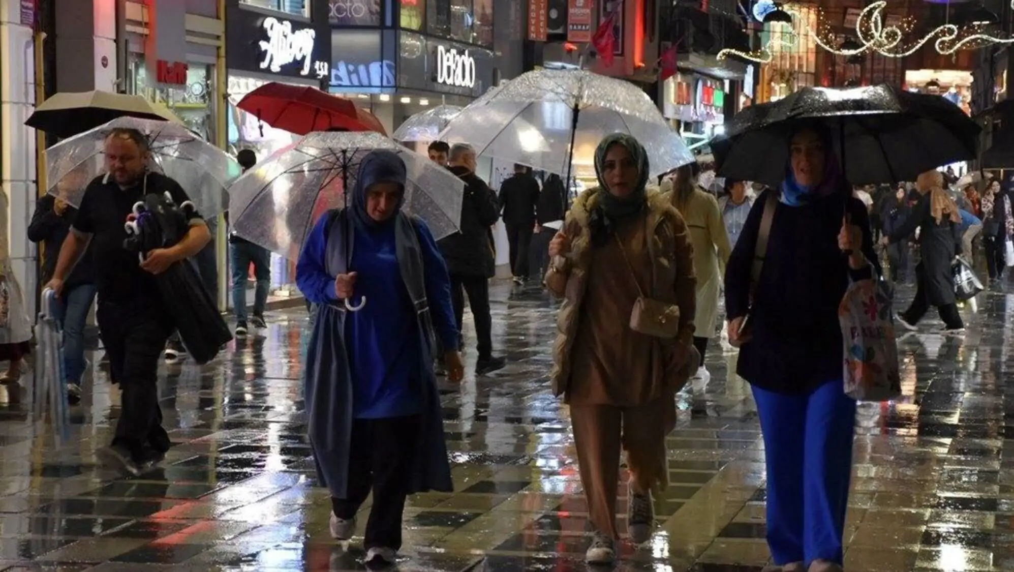 A group of people walking in the rain.