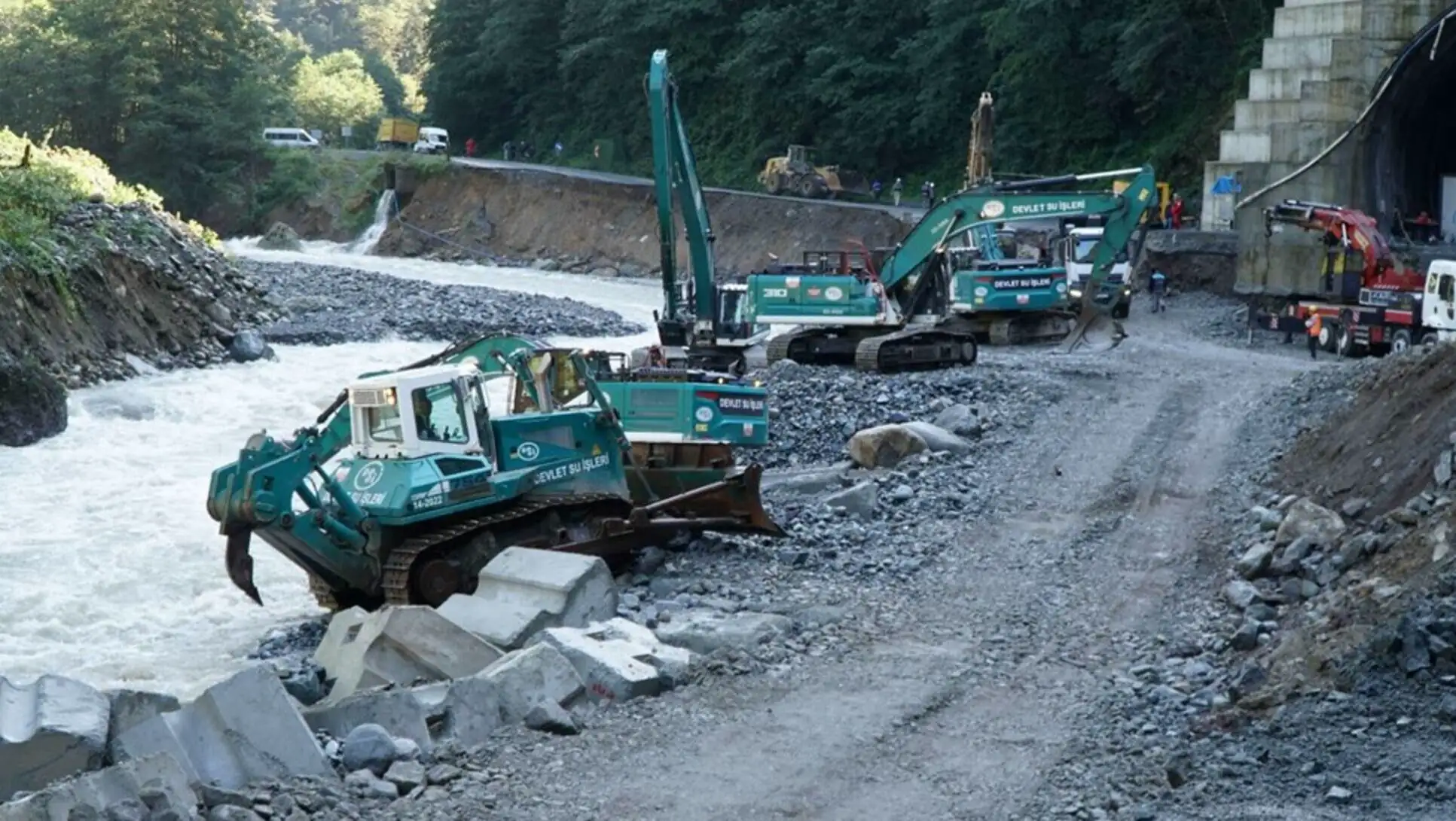 A group of construction vehicles on a road.