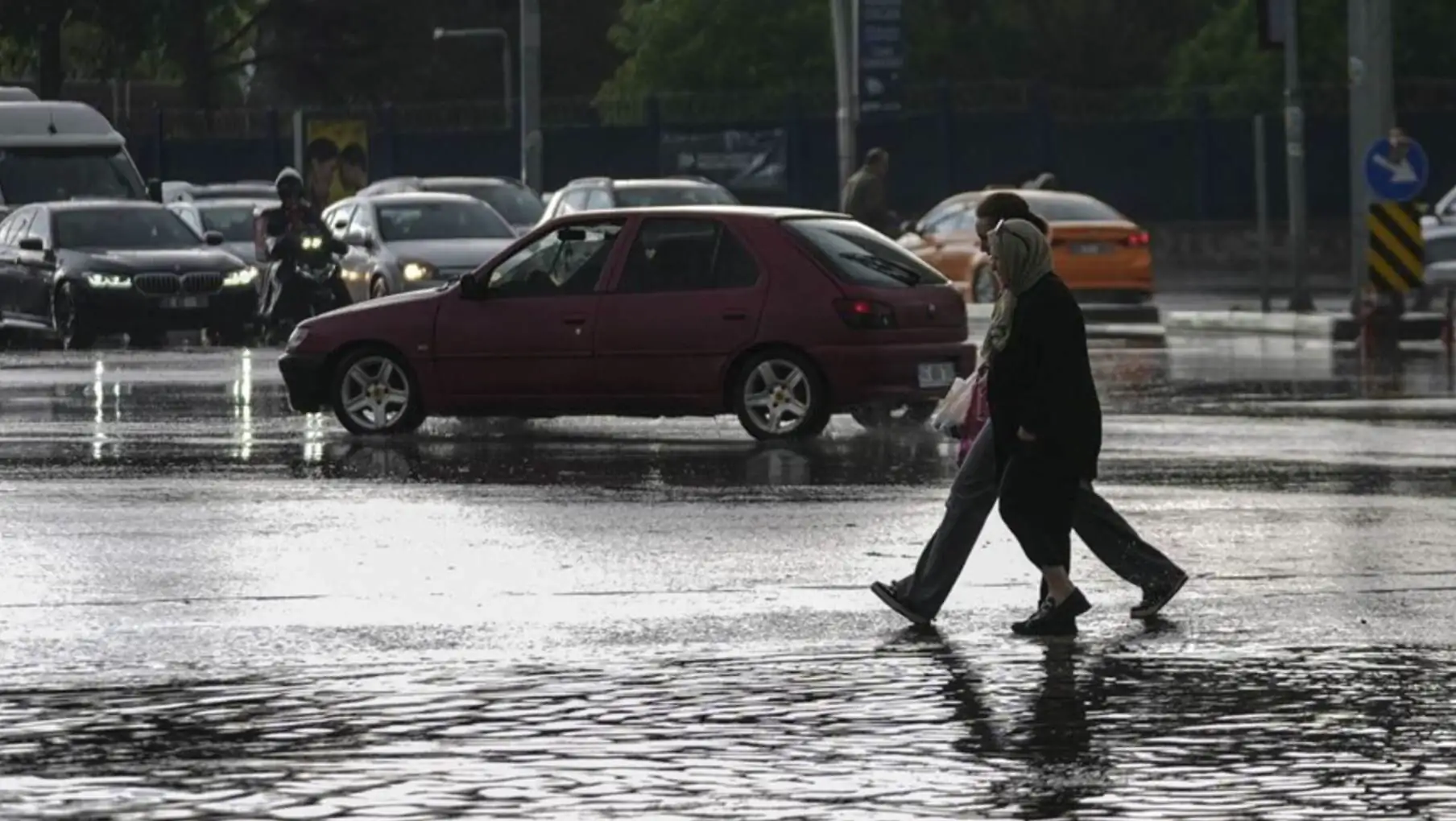 Flooding in Diyarbakir. A group of people crossing a flooded road. Flooding in Diyarbakir. A group of people crossing a flooded road.