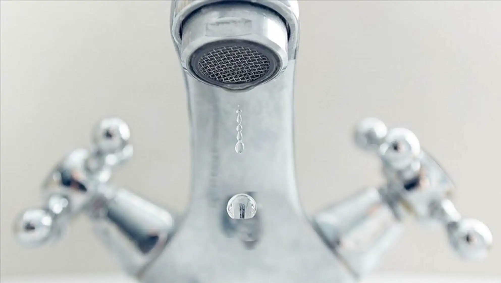 A close-up of a faucet. A close-up of a faucet.