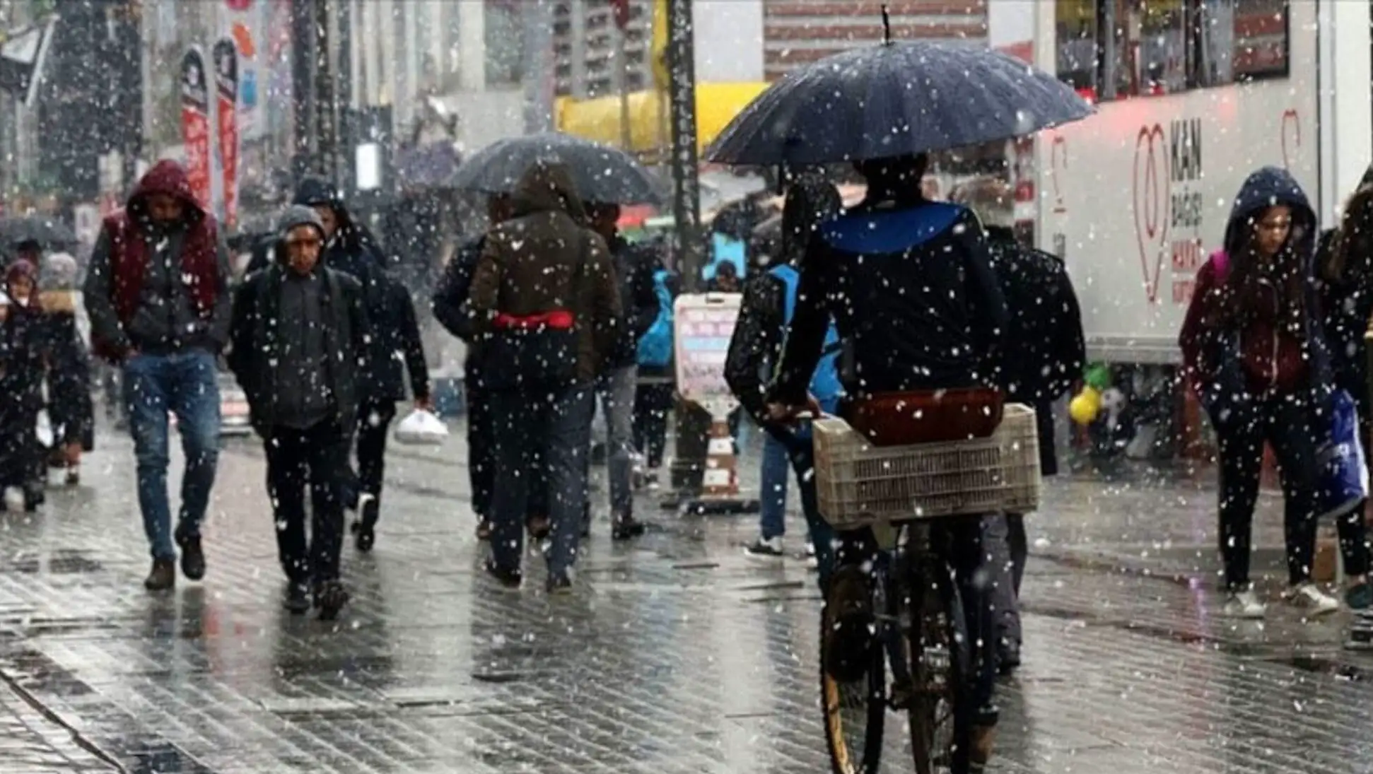 A person riding a bicycle in the rain. A person riding a bicycle in the rain.