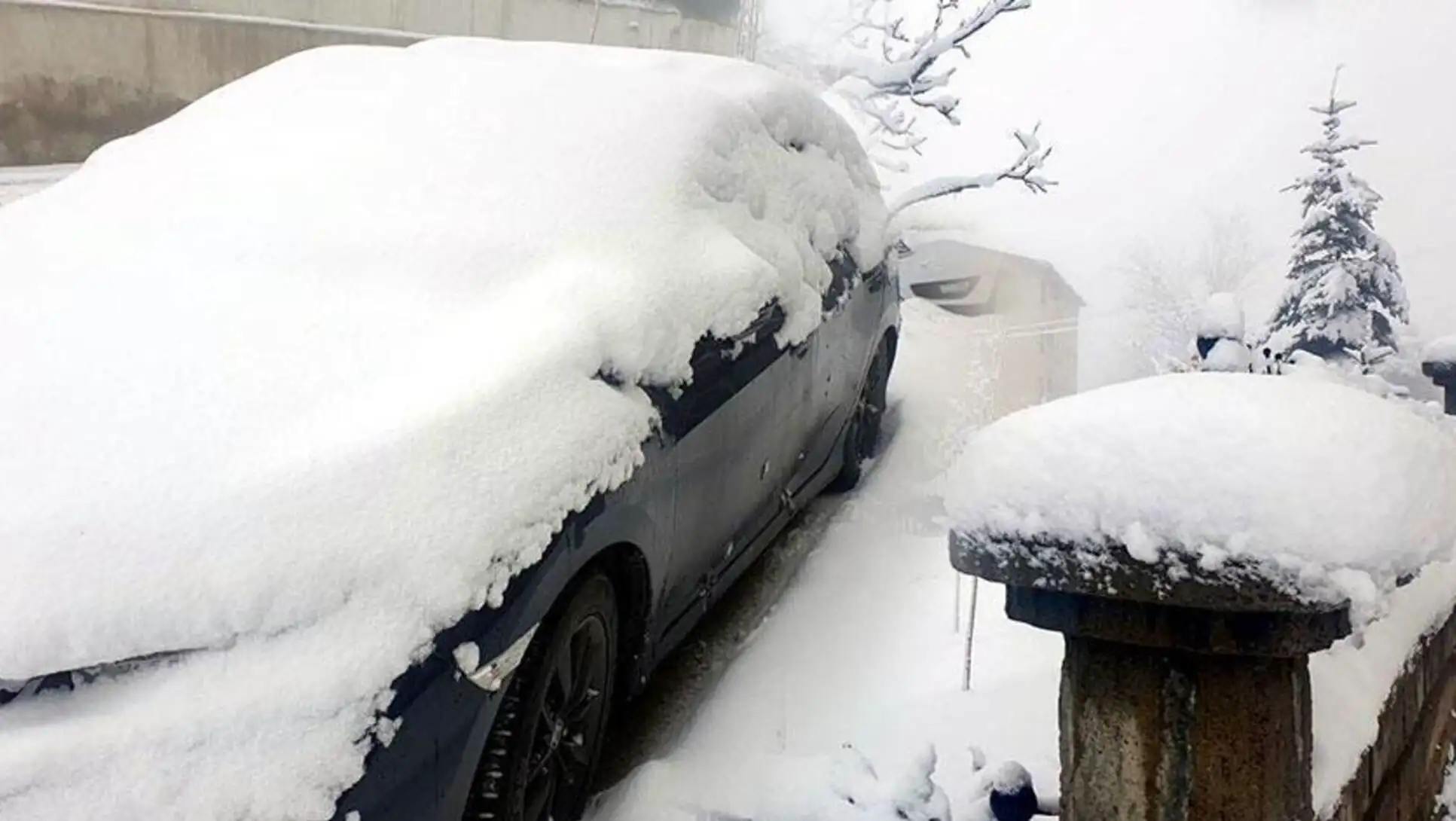 A car covered in snow. A car covered in snow.