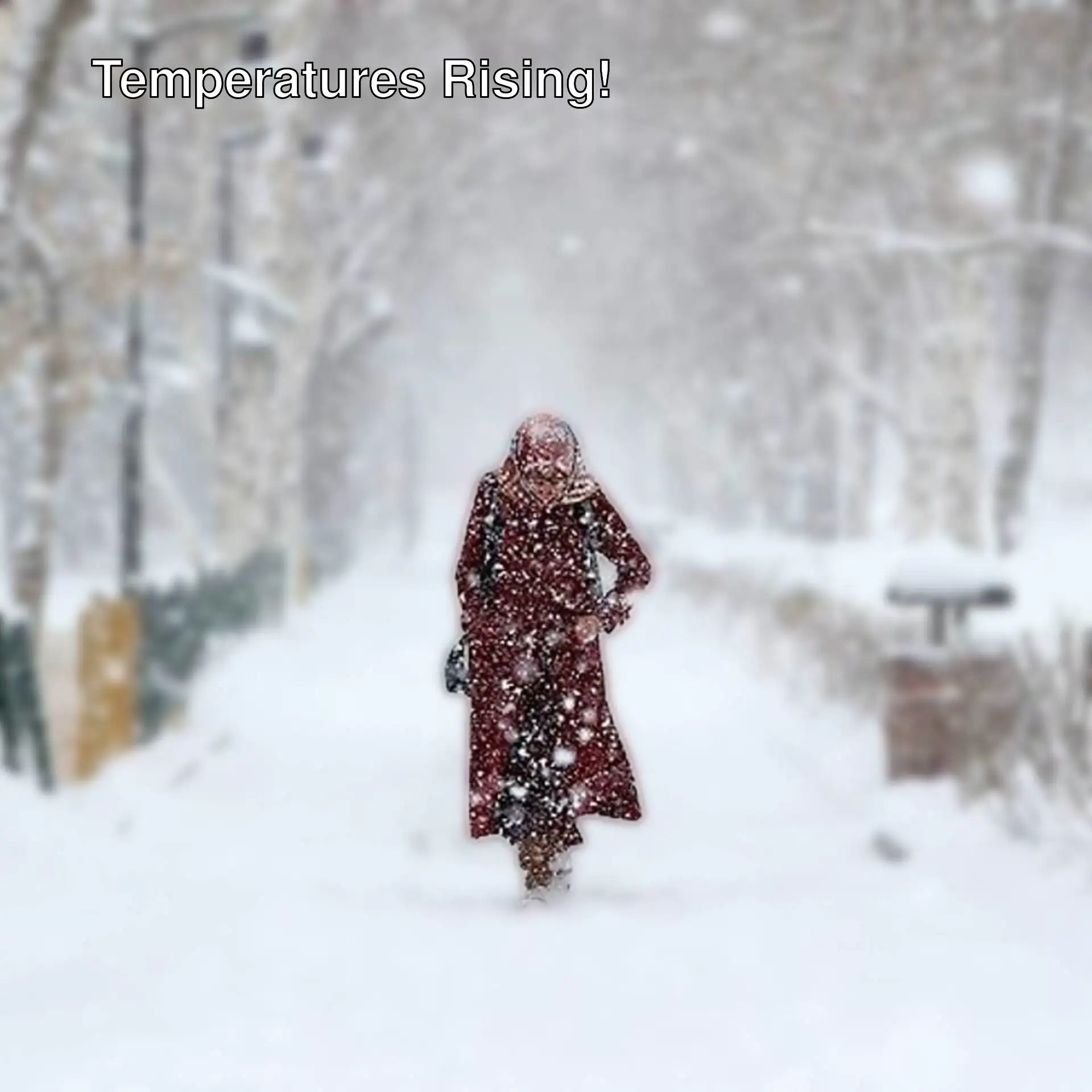 A person walking on a snowy sidewalk. A person walking on a snowy sidewalk.