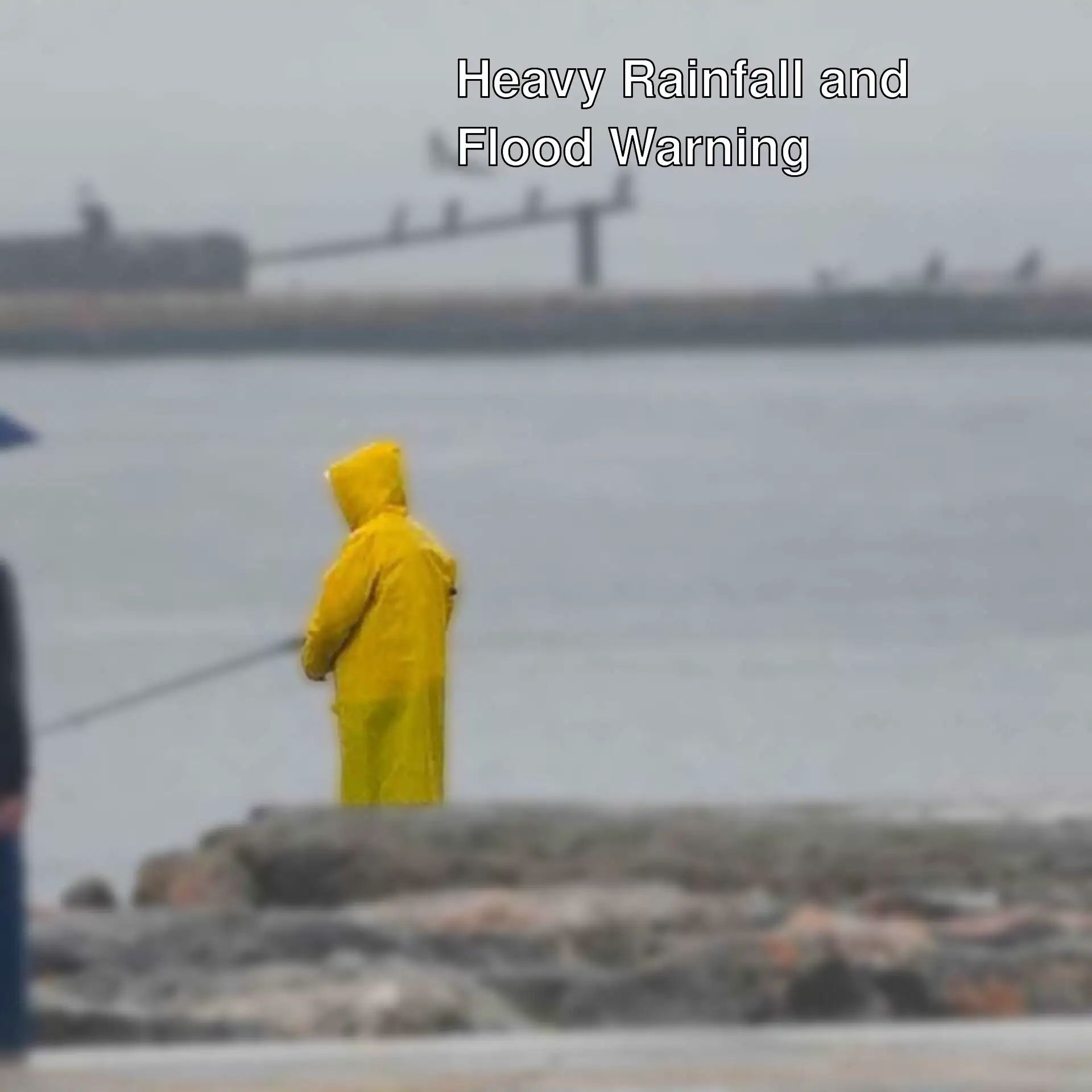 A person holding a fishing pole in a raincoat. A person holding a fishing pole in a raincoat.