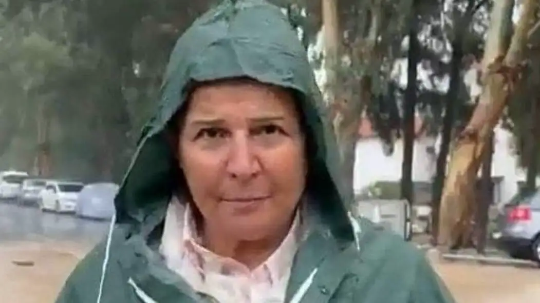 A woman wearing a raincoat during the flood. A woman wearing a raincoat during the flood.