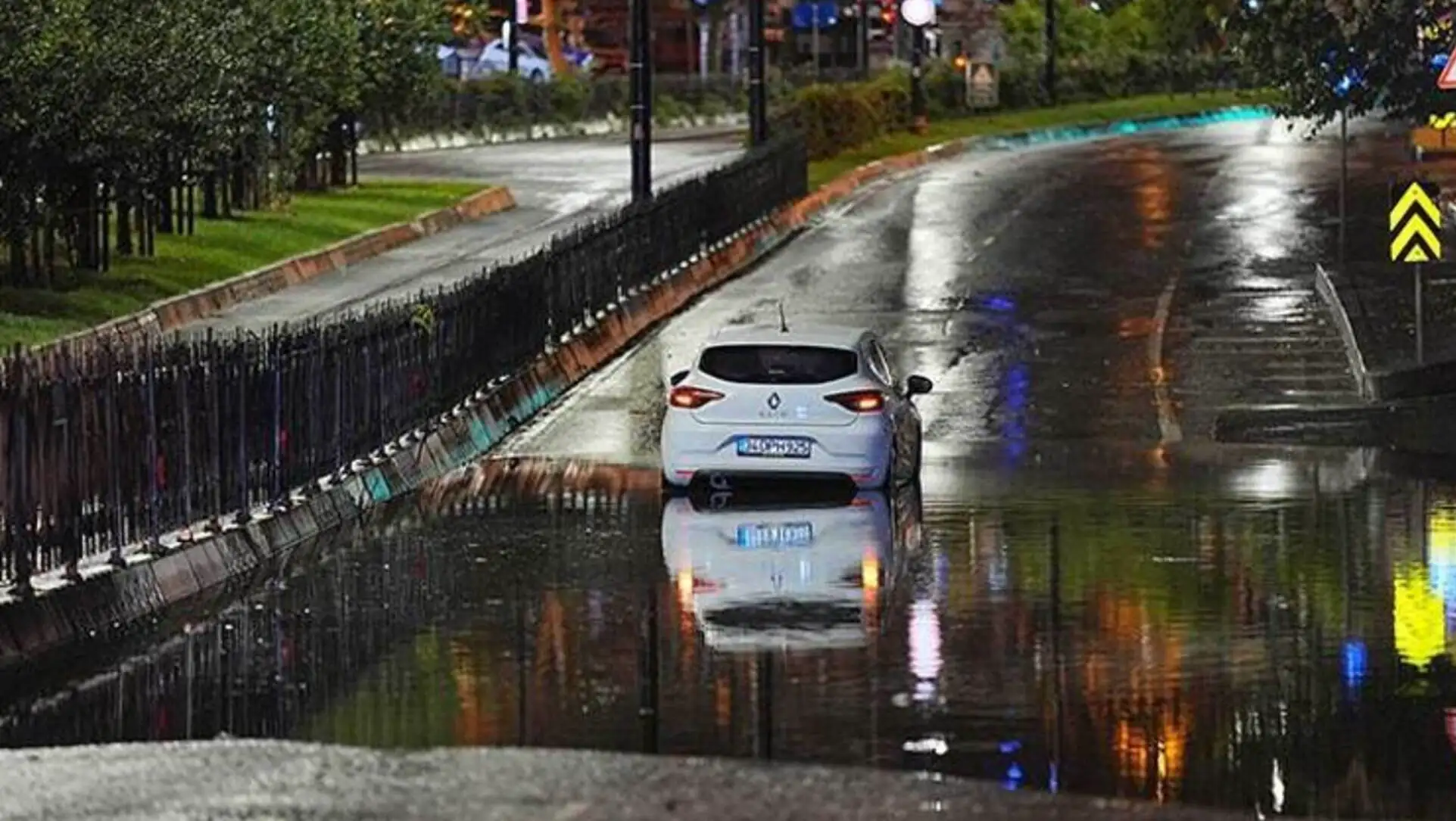 A car driving on a flooded road. A car driving on a flooded road.