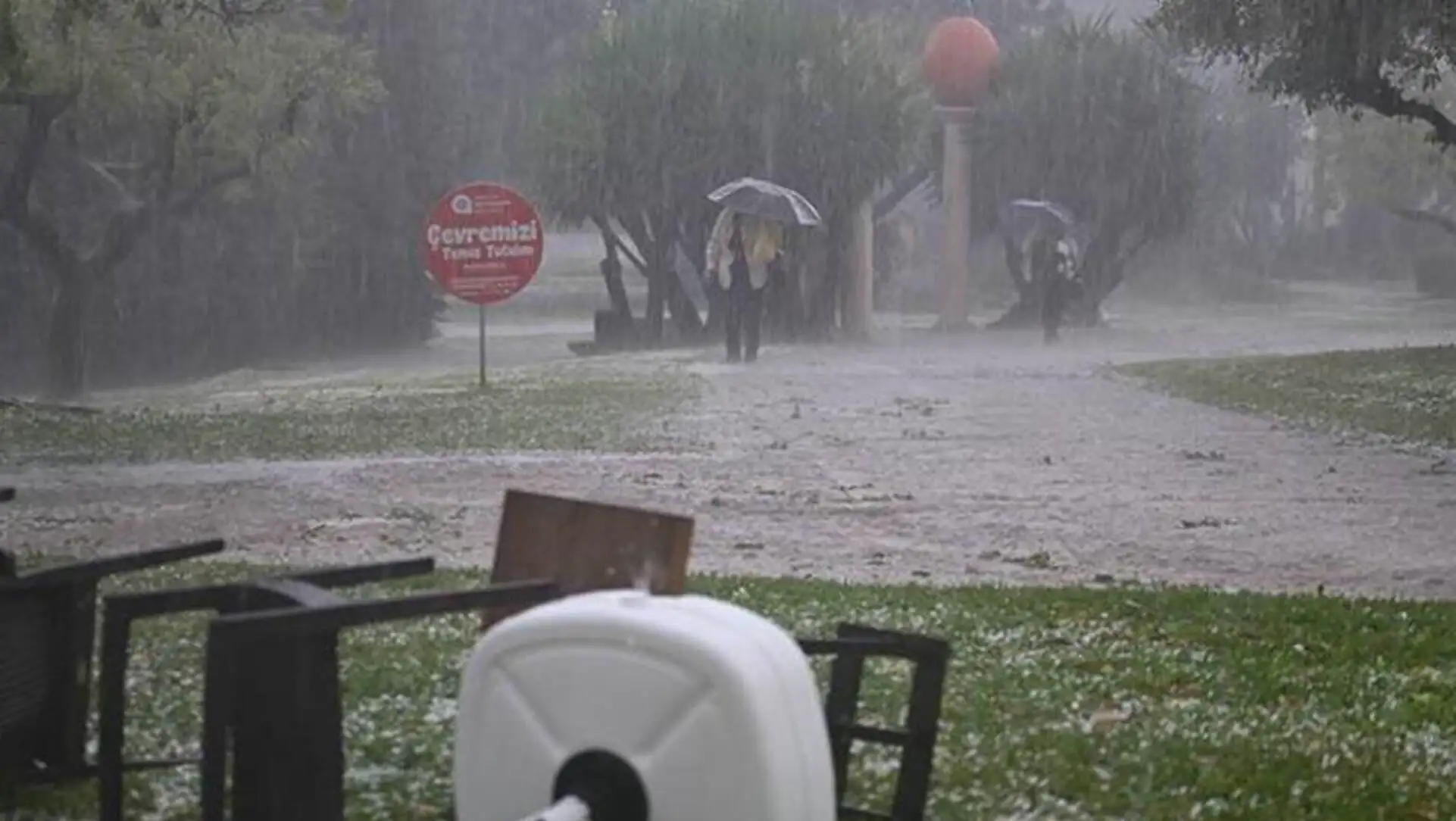 A person holding an umbrella in the rain.