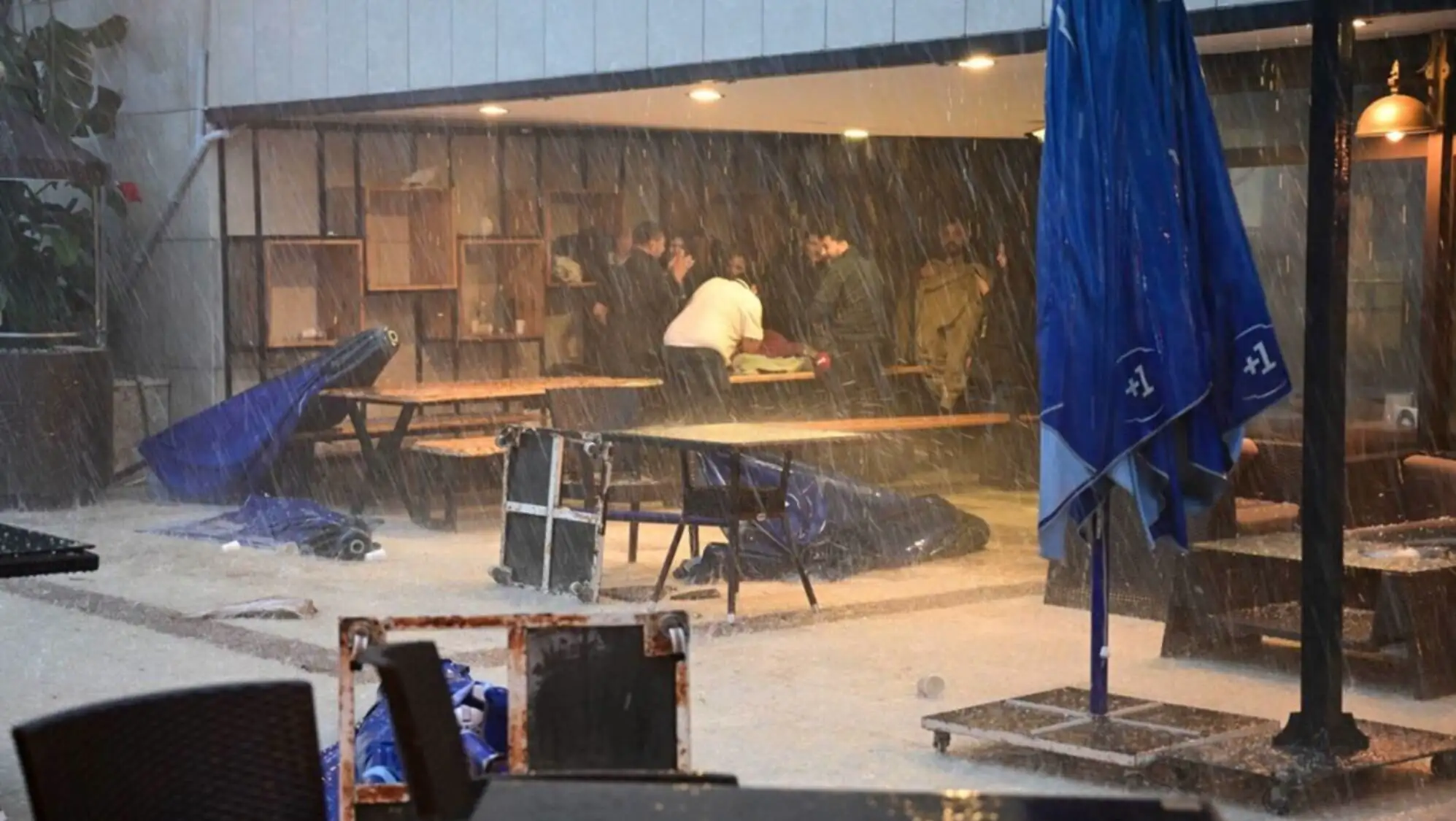 A group of people in the rain. A group of people in the rain.