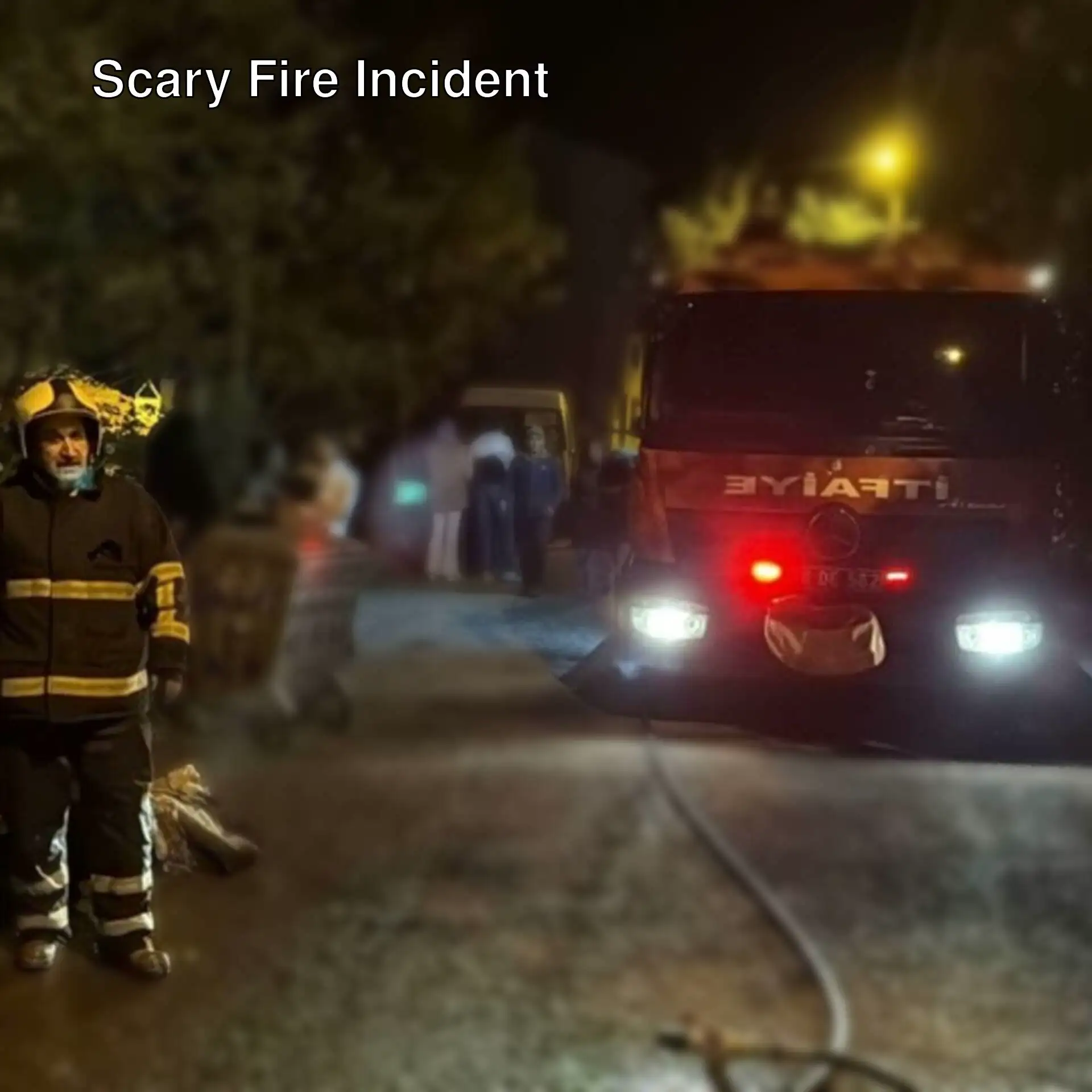 A firefighter standing next to a fire truck. A firefighter standing next to a fire truck.