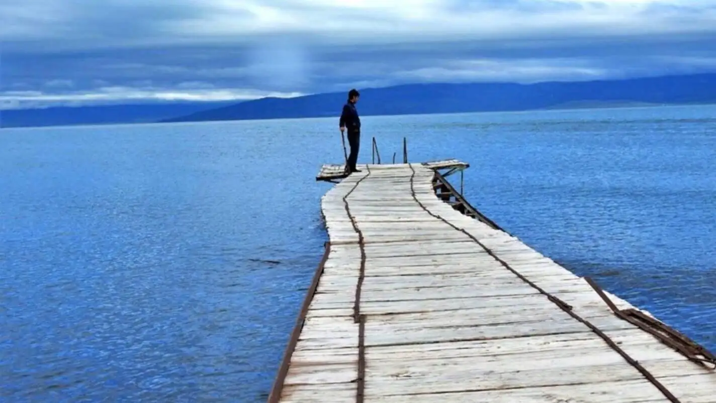 A man standing on a dock. A man standing on a dock.