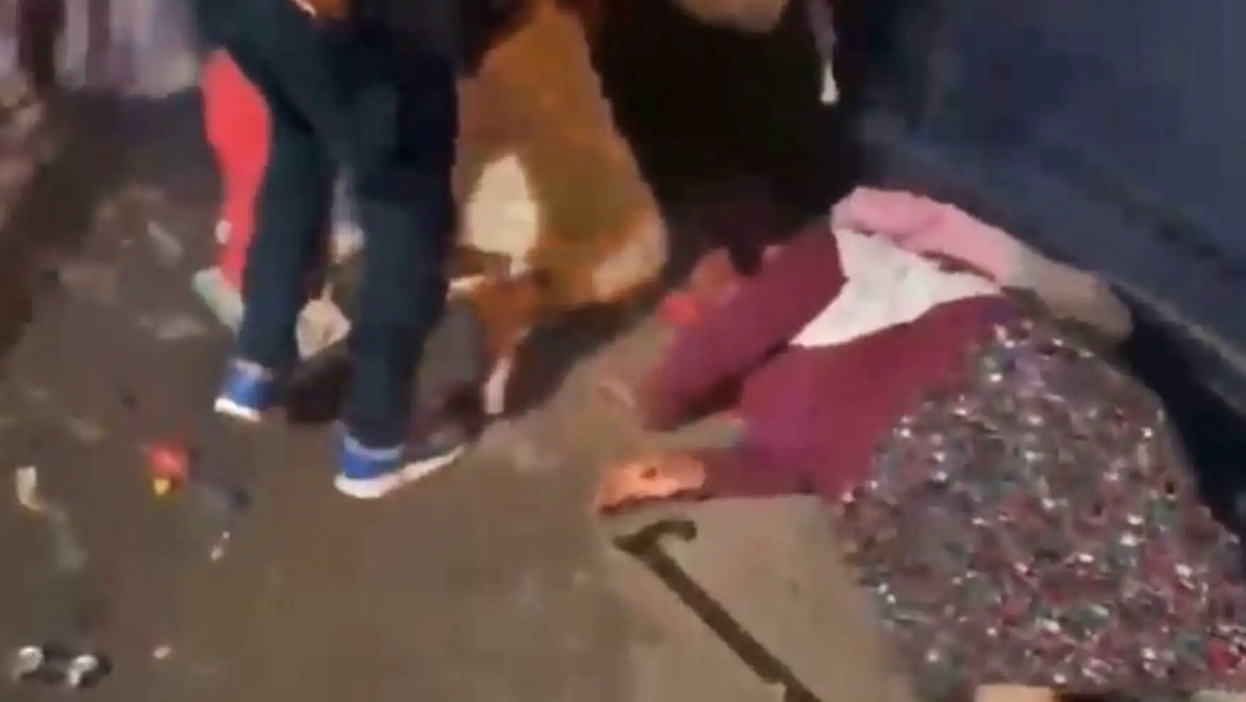 People lying on the ground during fireworks panic at a wedding.