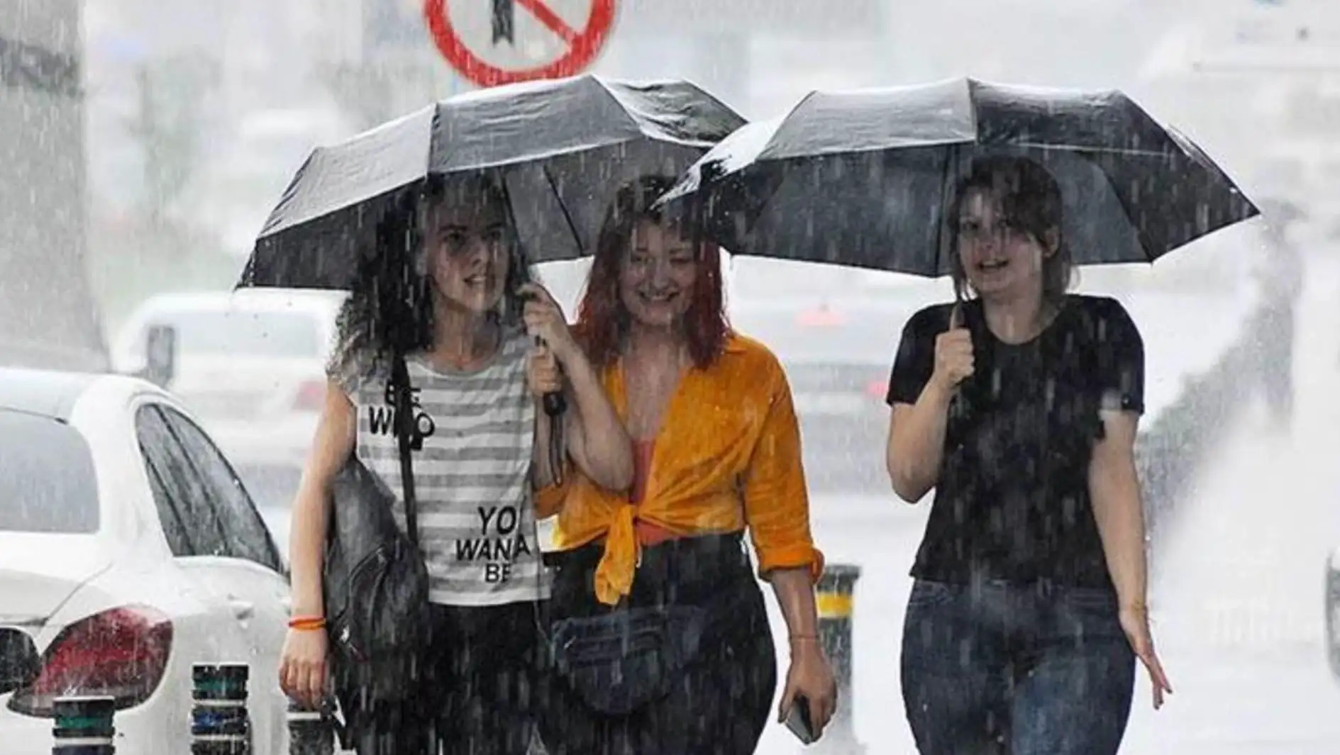 A group of people walking in the rain. A group of people walking in the rain.