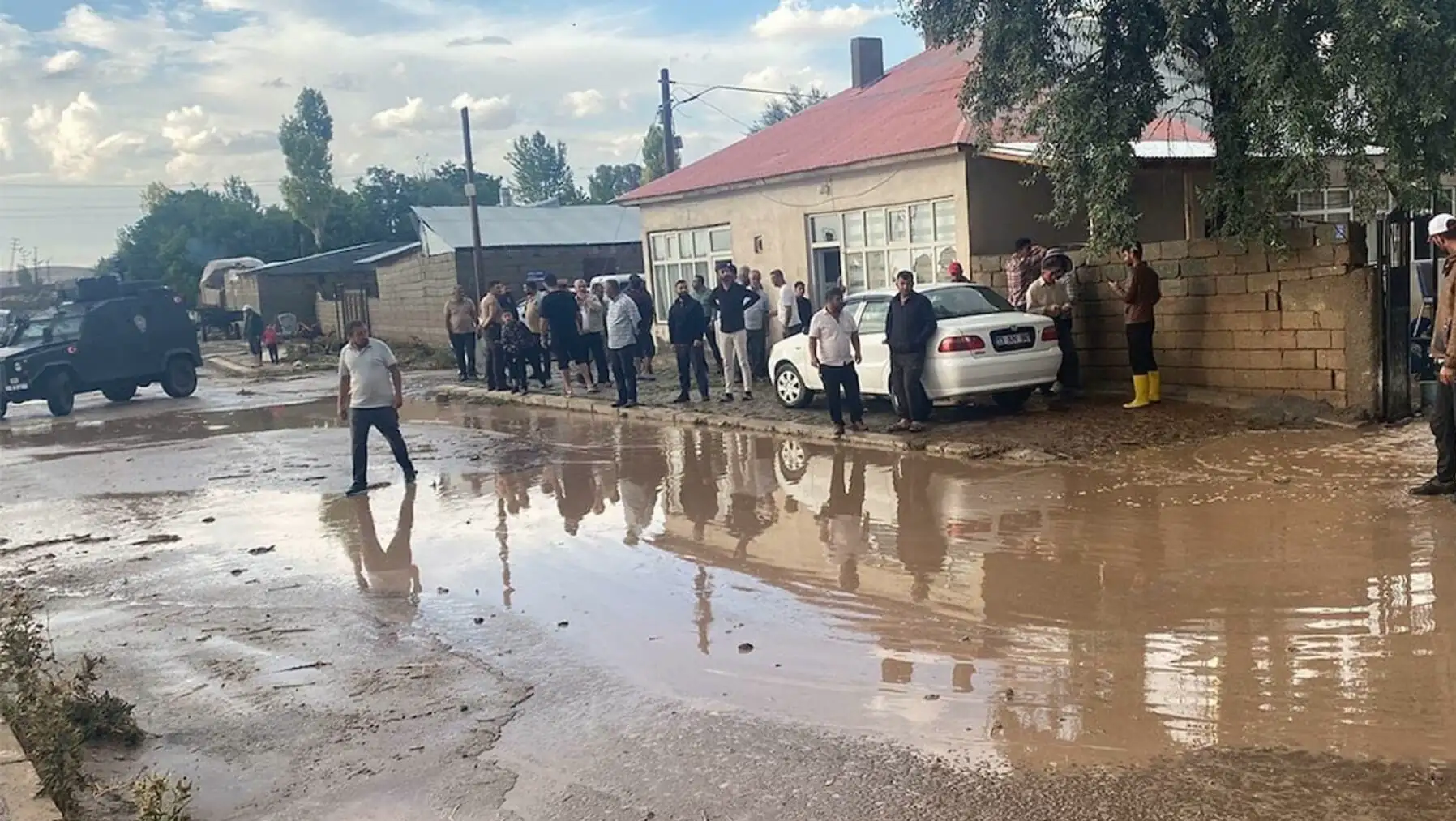 A group of people standing in flood water.