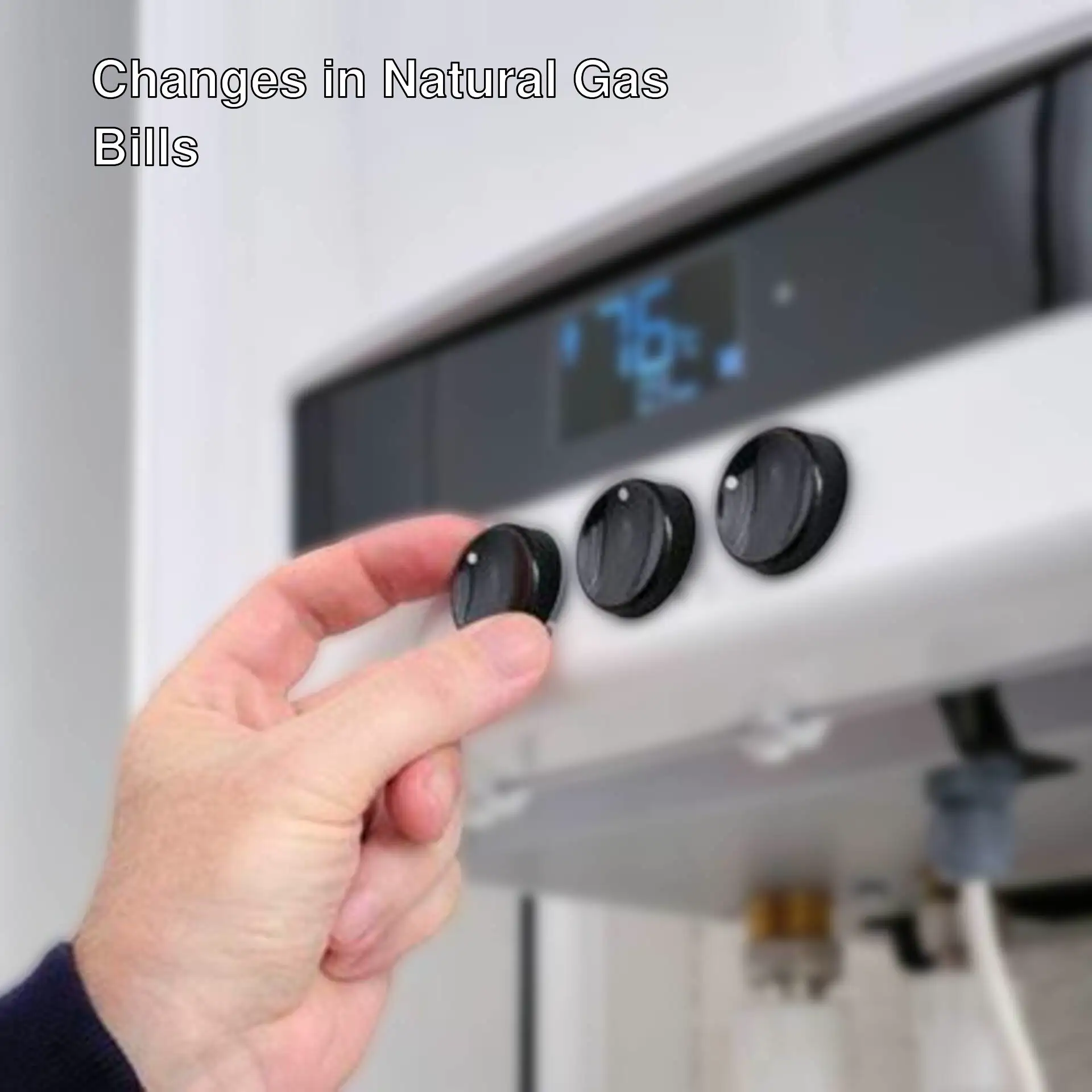 A hand turning a temperature on a gas heater.