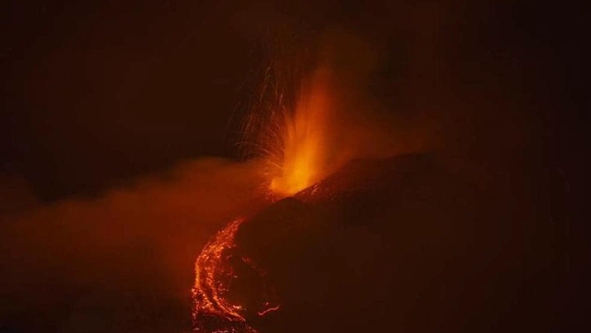 A volcano erupting at night. A volcano erupting at night.