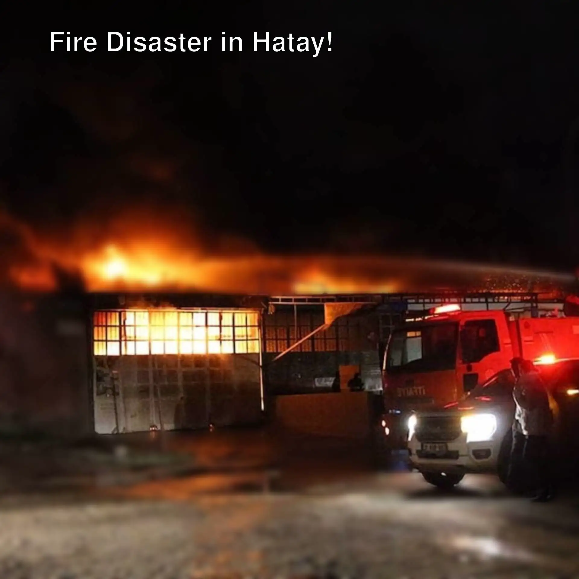A fire on a building at night.